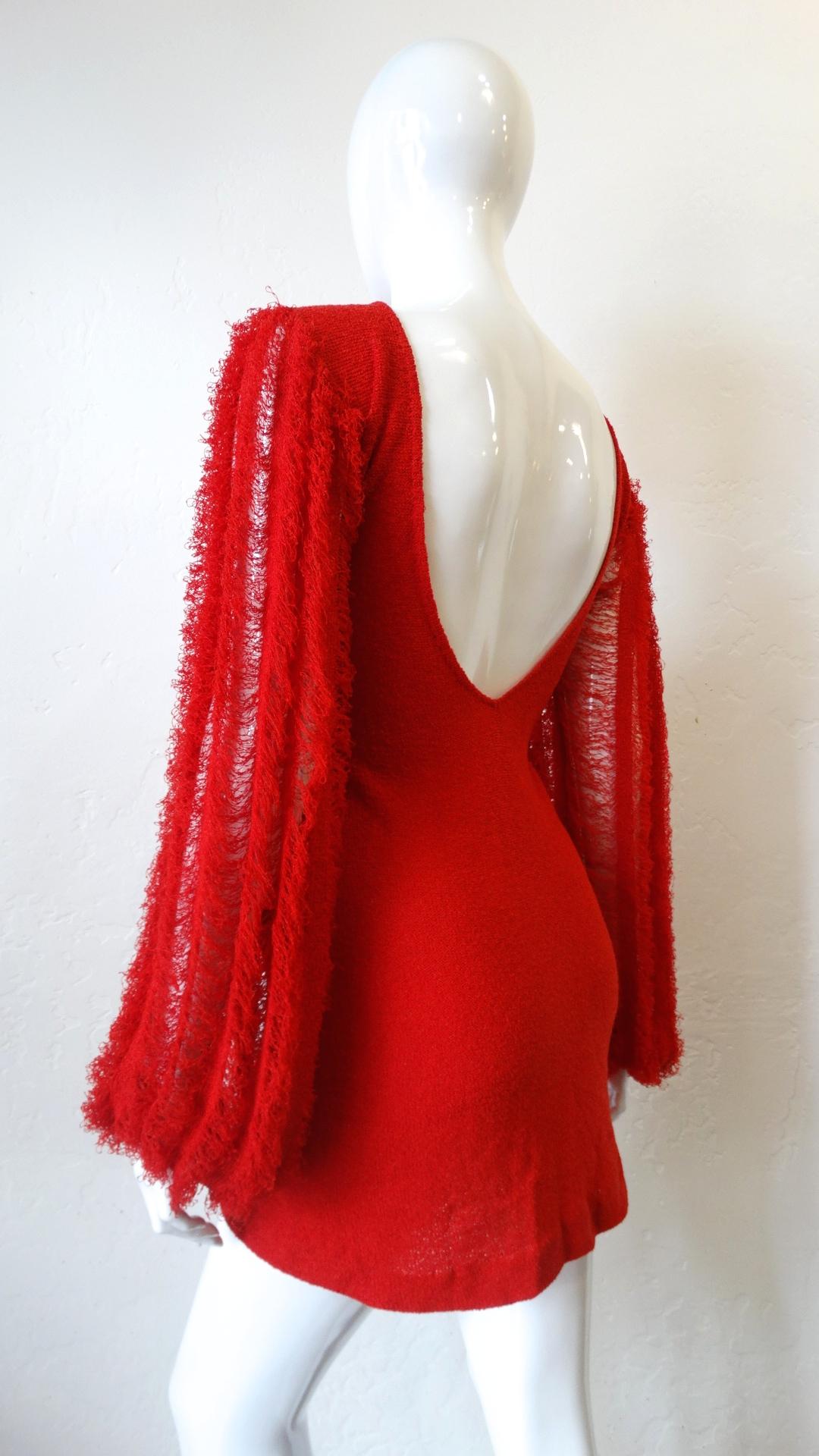 The Most Adorable Mini Dress Is Here! Circa 1980s, this knit red mini dress features a scoop neckline and shaggy dramatic bishop sleeves. The back is cut in a flattering V line. The perfect dress for a night out paired with funky shoes! Designer