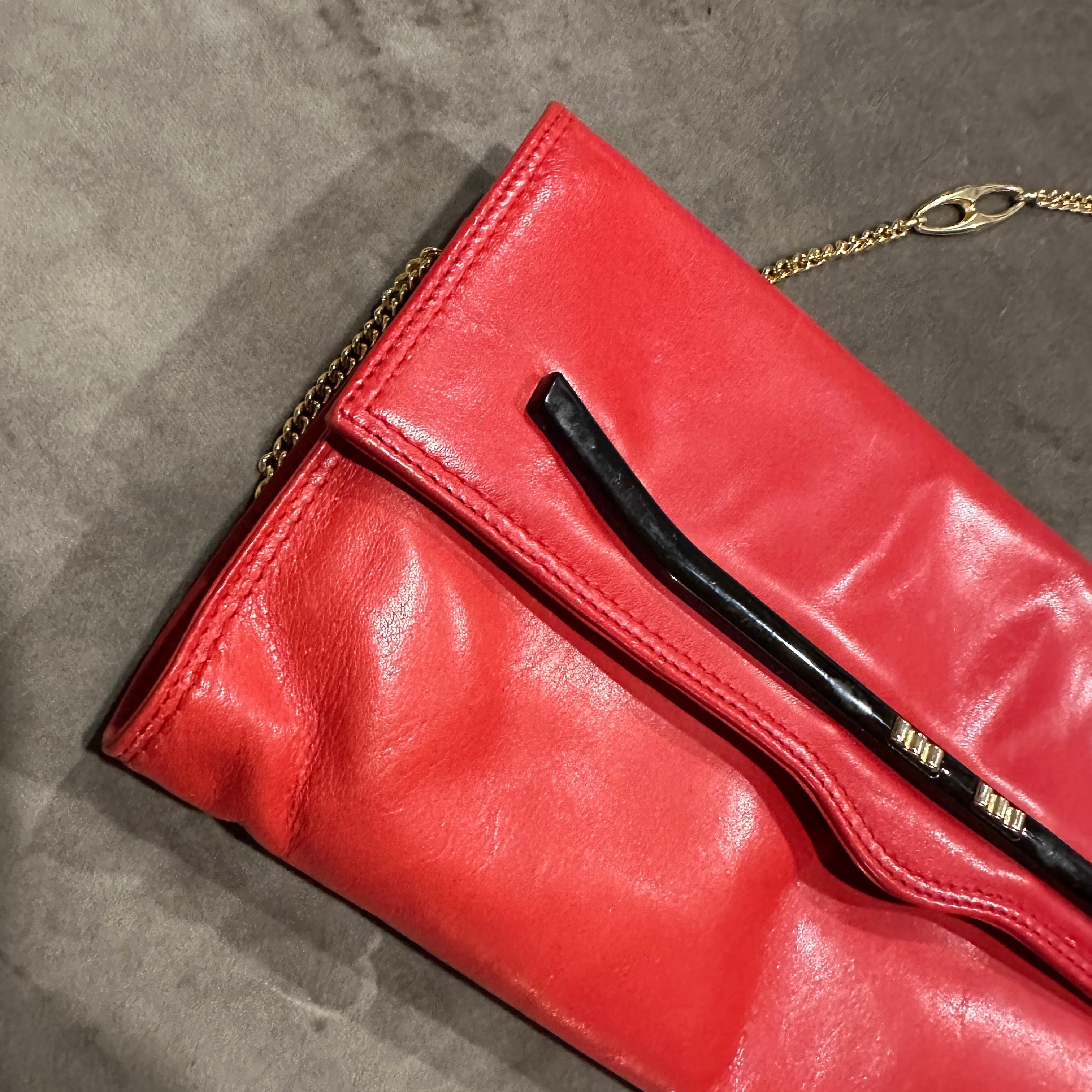 Vintage 1980s Red Leather Italian Shoulder Bag with Brass Chain
Step back in time with this stunning and sophisticated 1980s vintage shoulder bag, a true testament to the timeless craftsmanship of Italian leather goods. Crafted from a rich, vibrant