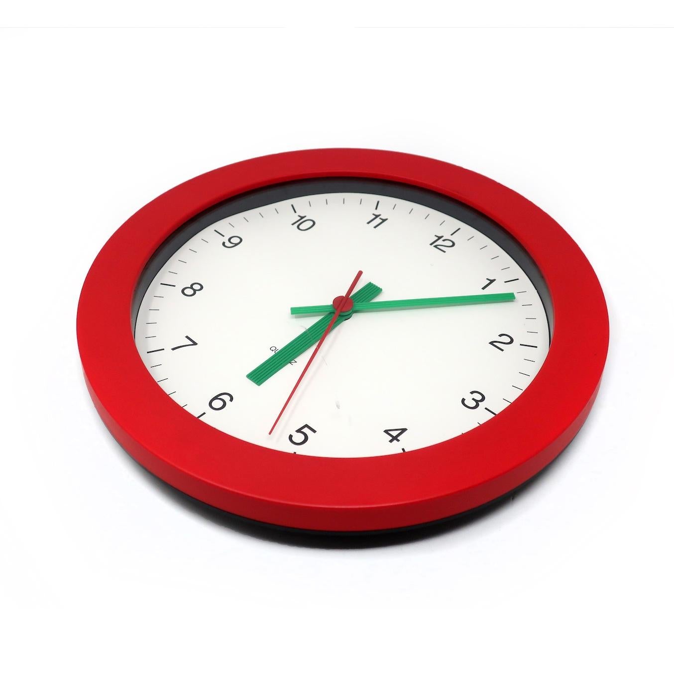 A simple and beautiful 1980s postmodern wall clock by famed German clockmaker Junghans. Red frame, white face with black numbers, and textured green hands. Striking contrast of colors and fantastic pop of colors!

In good vintage condition with