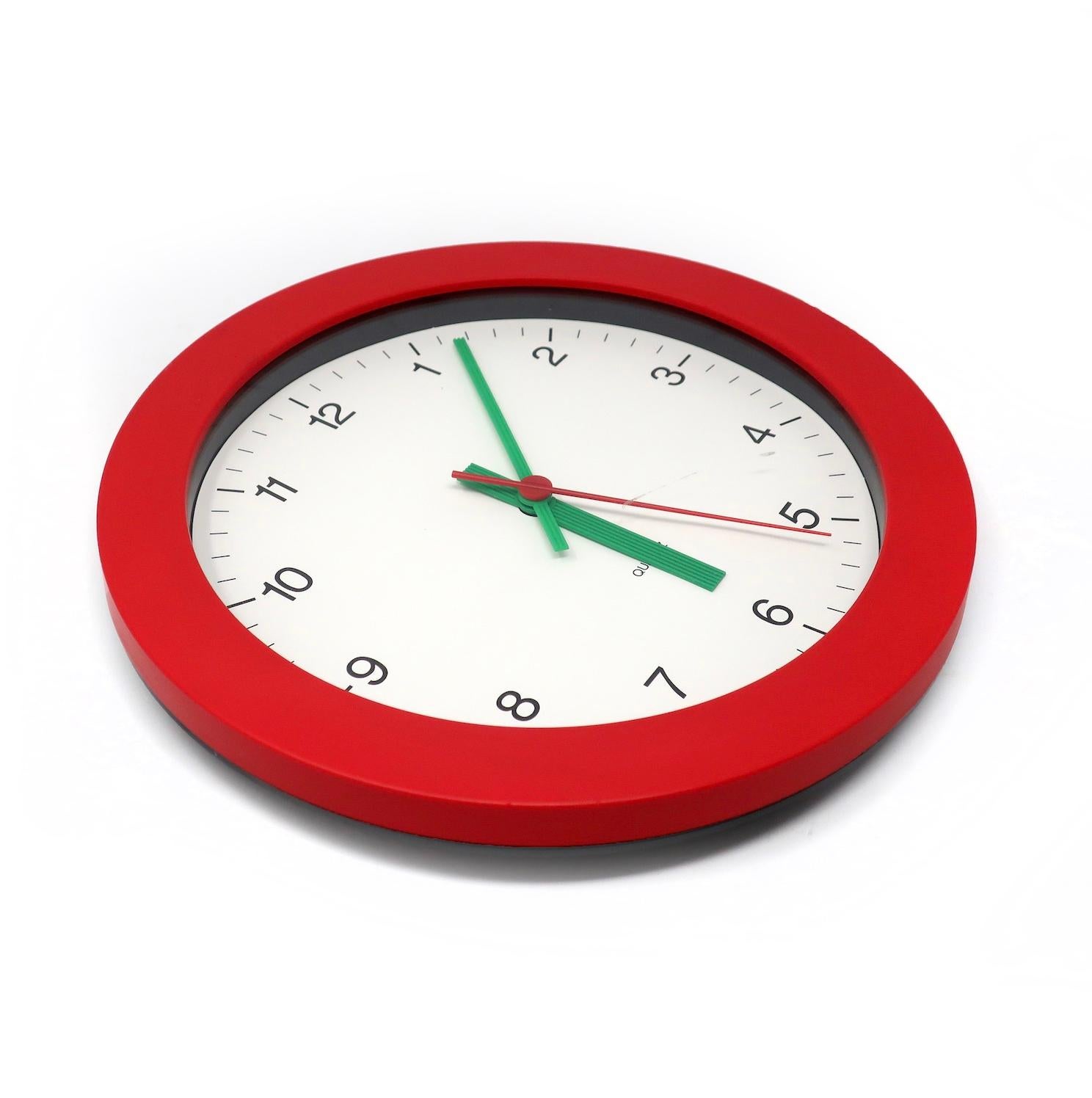 A simple and beautiful 1980s postmodern wall clock by famed German clockmaker Junghans. Red frame, white face with black numbers, and textured green hands. Striking contrast of colors and fantastic pop of colors!

In good vintage condition with wear