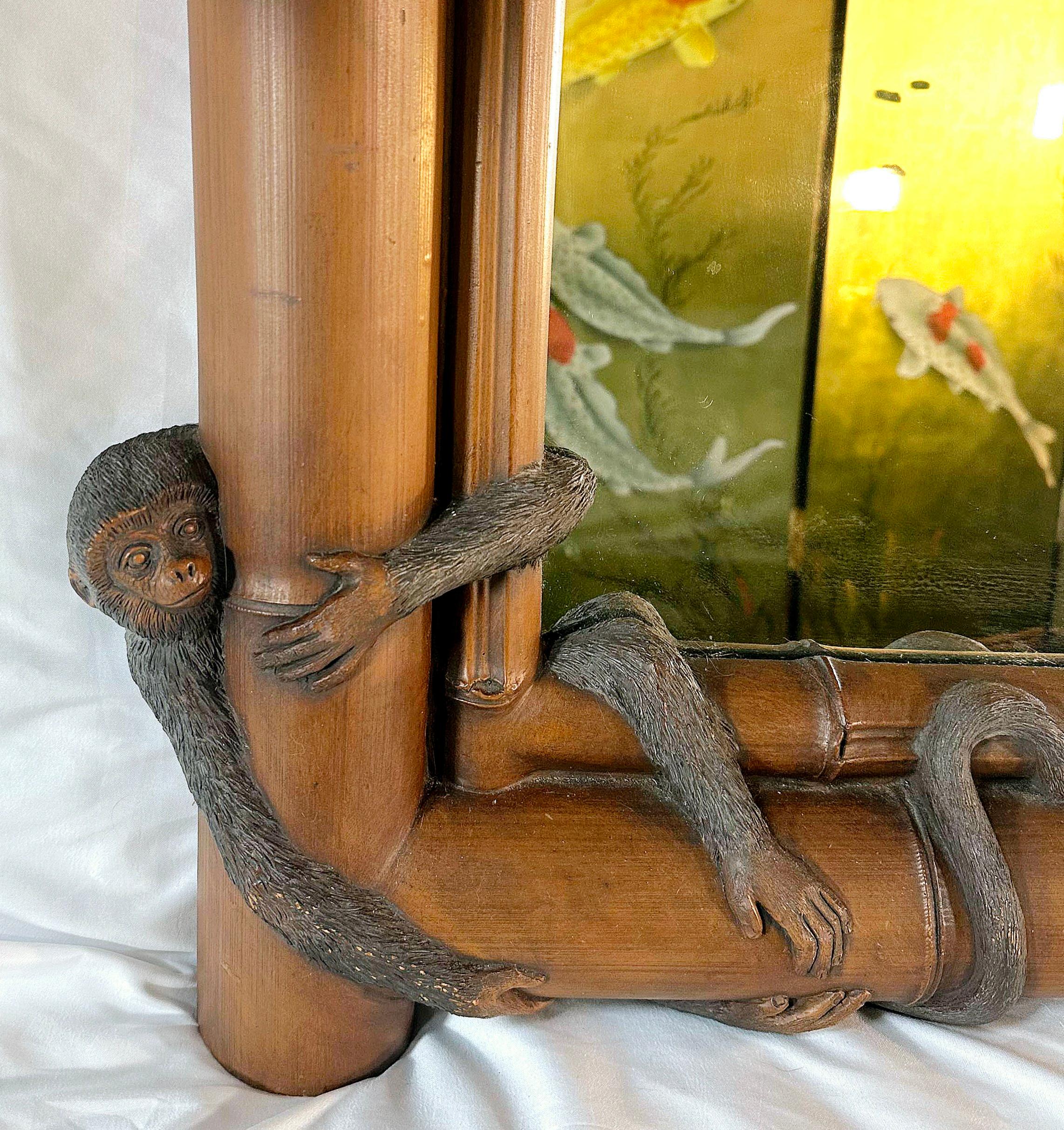 Reminiscent of Earnest Hemingway, Maitland Smith and Tommy Bahama.
Late 20th Century Faux Bamboo Mirror flanked with four monkeys. 
Made of either a composite or resin material. 
The monkeys are painted and the bamboo is accented with color. 
Would