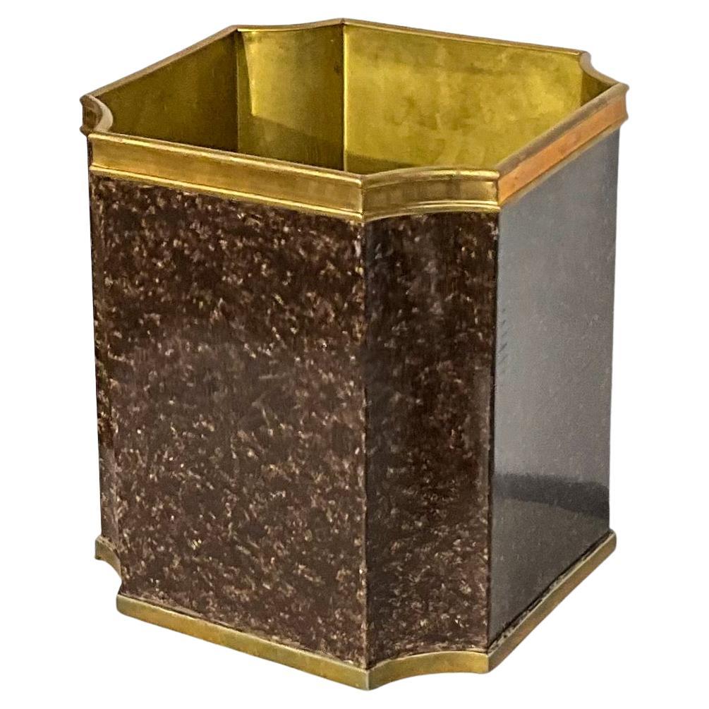 This is a late 20th century regency style faux tortoise and brass trash can  or planter. It is in good condition and unmarked.