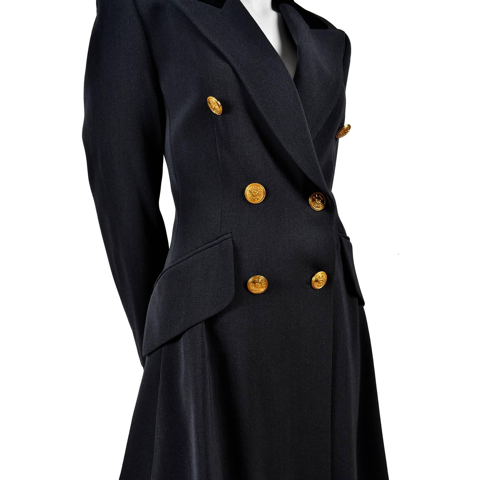 This vintage gray suit was designed by Rena Lange in the 1980's and is made in a wool/silk blend. The long, double breasted jacket has front flap pockets, a notched lapel and a black cotton velvet collar.  The gold buttons are marked Rena Lange and