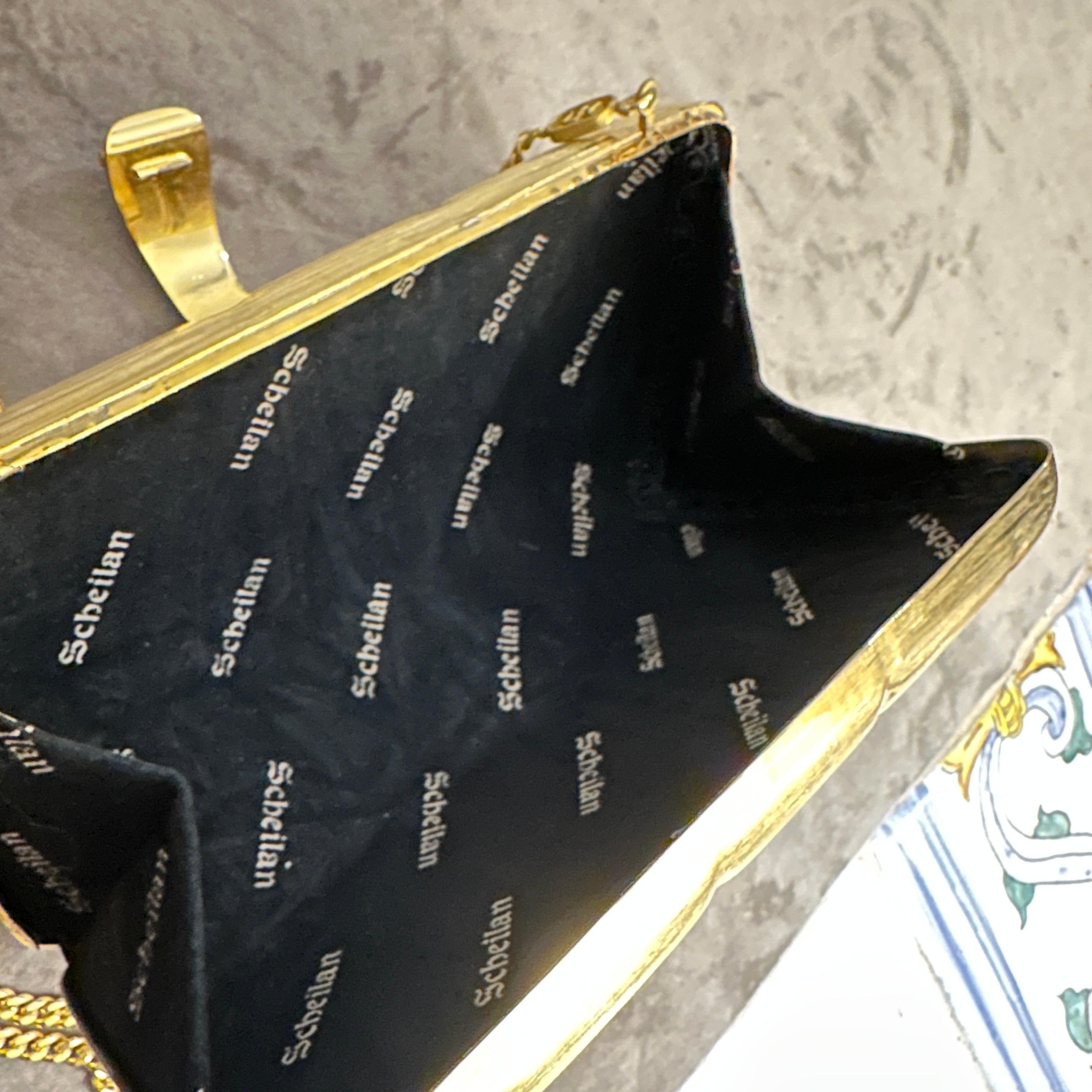 This Scheilan Firenze evening bag is a captivating example of 1980s fashion. Its bold design, metallic finish, and ornate details make it a true statement piece. It's a perfect accessory for those who appreciate vintage glamour and want to add a