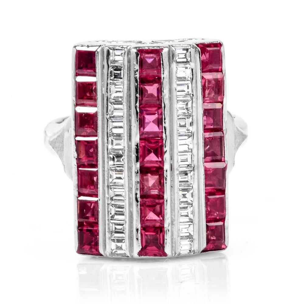 This opulent cocktail ring with rubies and diamonds is crafted in solid platinum, weighs 12.6 grams and measures 20 mm wide and 7mm height. Designed as a three-level rectangular plaque, the ring exposes three rows set with square-cut rubies and two