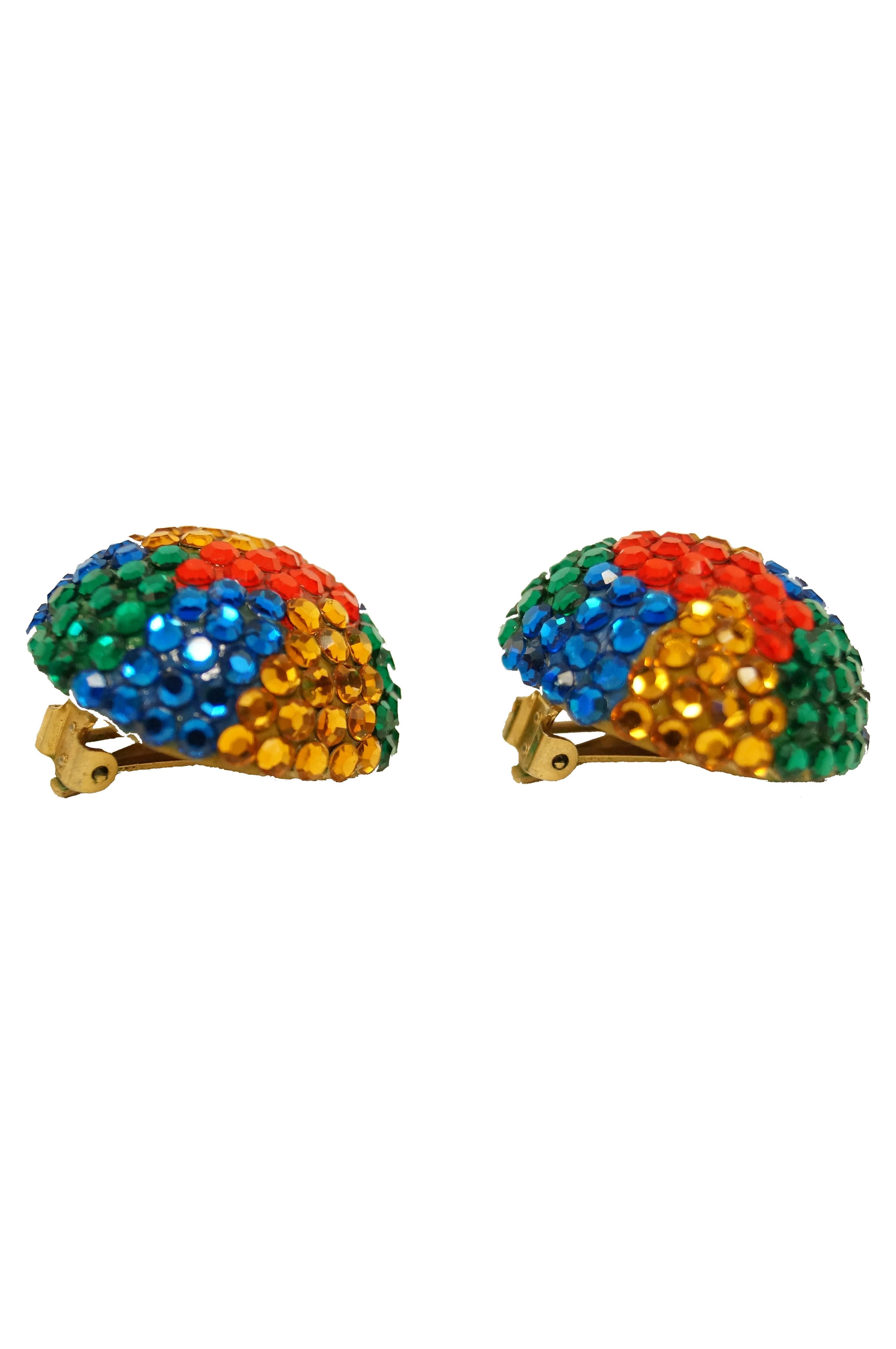 Eye - catching multi color clip earrings by Richard Kerr! The earrings are a half sphere covered in blue, green, red, and yellow multifaceted rhinestones that dazzle and delight! 

Richard Kerr is known for his bedazzled 80's style!