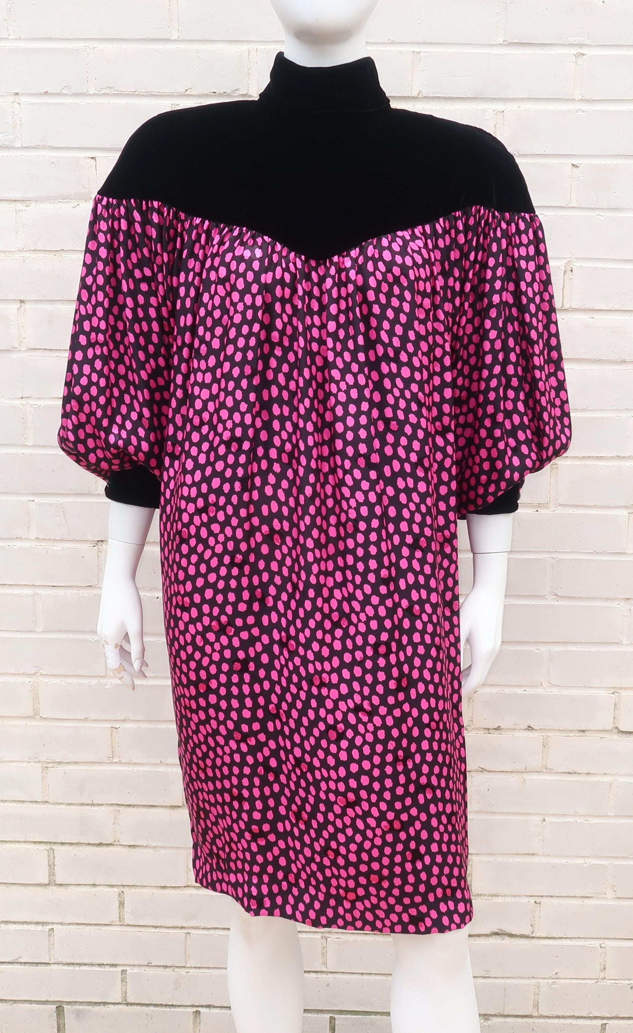 A 1980's period perfect silk jacquard dress by Rickie Freeman for Teri Jon including big shoulder pads, a voluminous silhouette and tapering hemline.  The body of the dress features a black silk fabric accented by abstract magenta polka dots and a