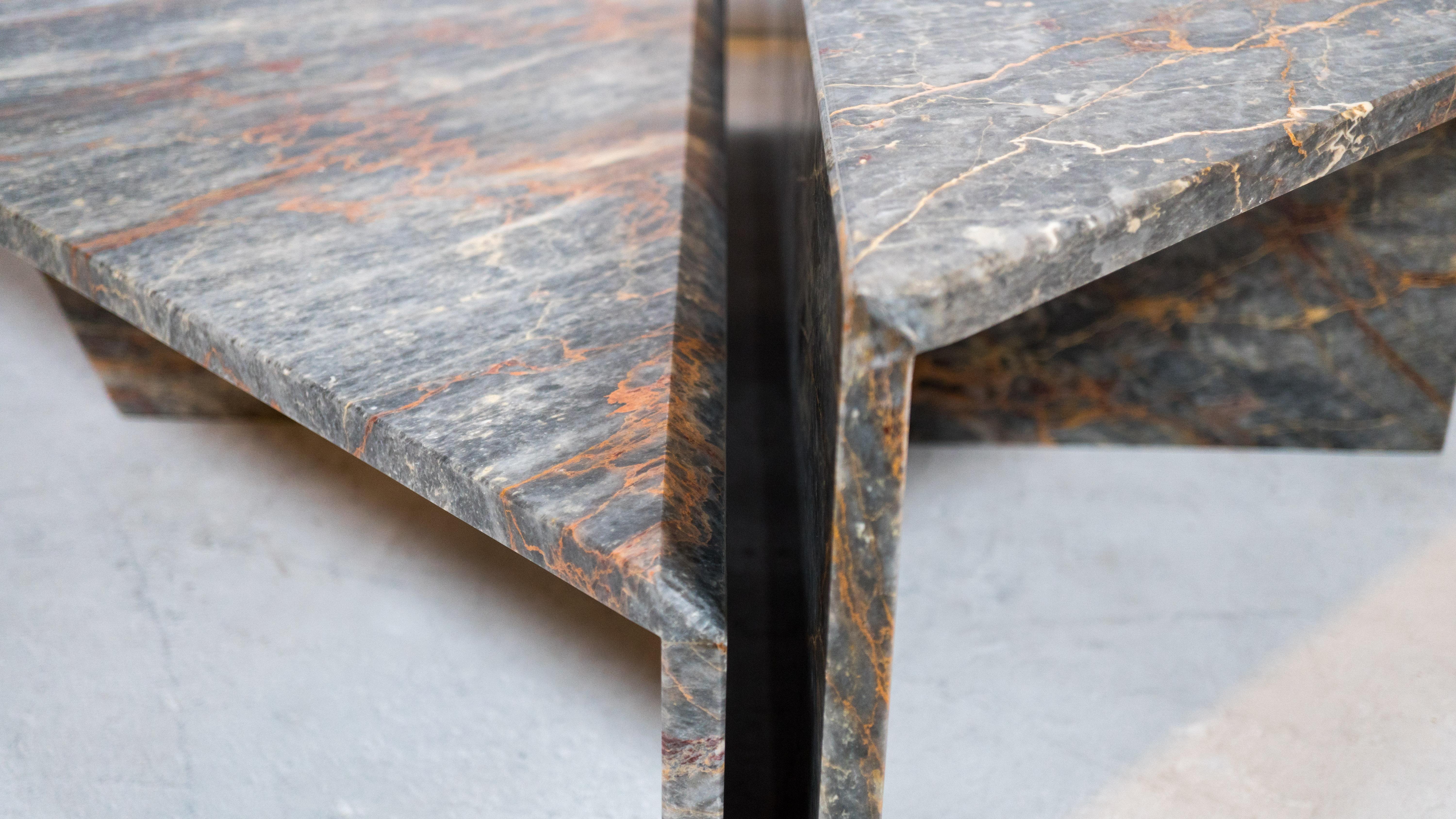 Beautiful two tiered sculptural variegated marble coffee table by Roche Bobois, circa 1980s. Comprised of two triangular pieces that fit together to create one large piece. Features hues of gray, white, orange, with veining details and a polished