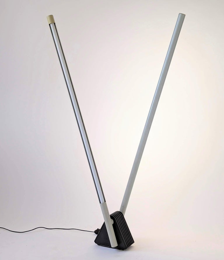 Iconic versatile 'Sistema Flu' floor lamp consist of two arm that move up and down a full 180 degree (floor to floor) with fluorescent or LED tube.

The fluorescent plastic shield does rotate a full 360 degree to aim light output where