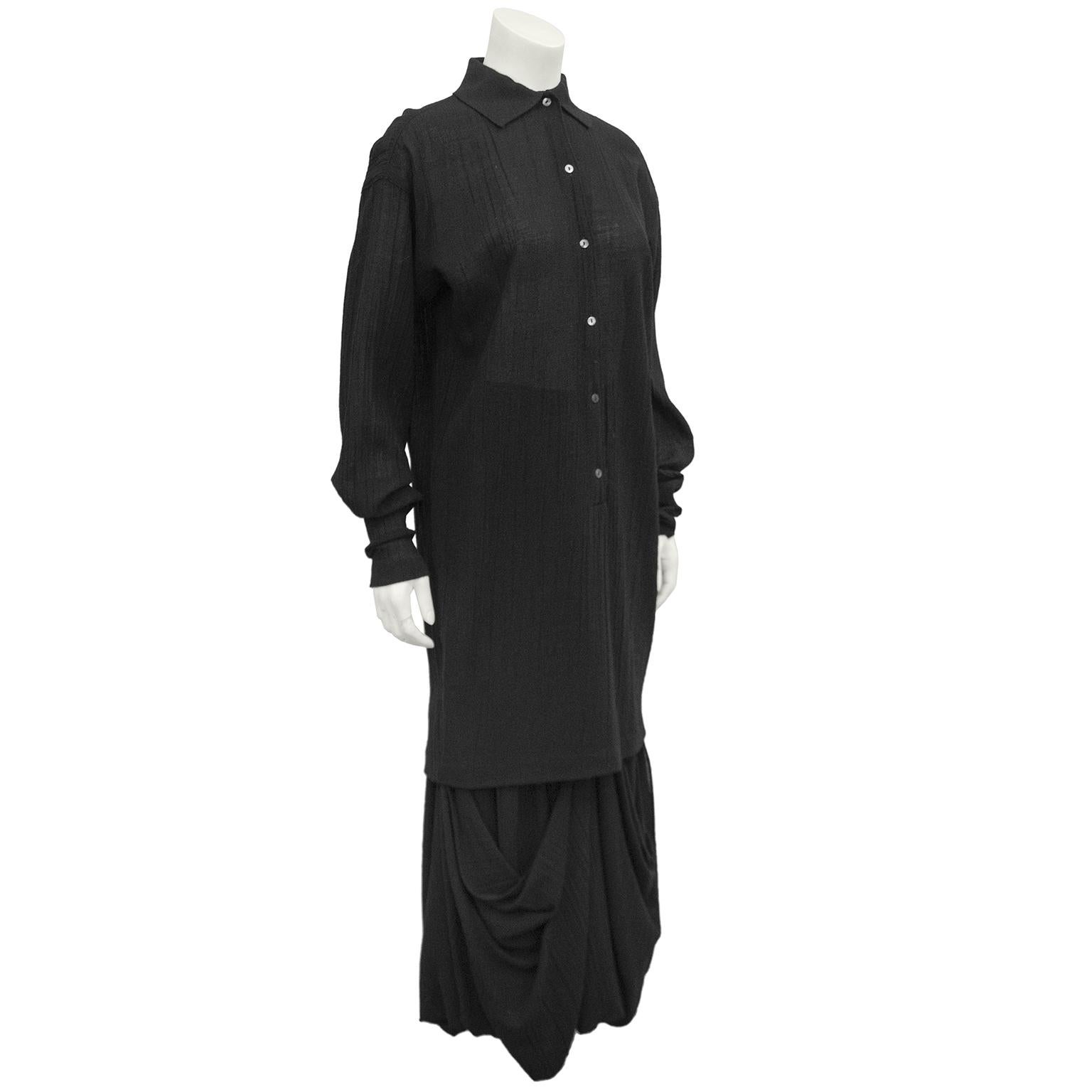 1980s Romeo Gigli black natural cotton ensemble. Long tunic blouse with a knit collar and small grey mother of pearl buttons. Loose fit through body, but tapers towards hem. High waisted maxi skirt with ruching and large pick ups creating beautiful