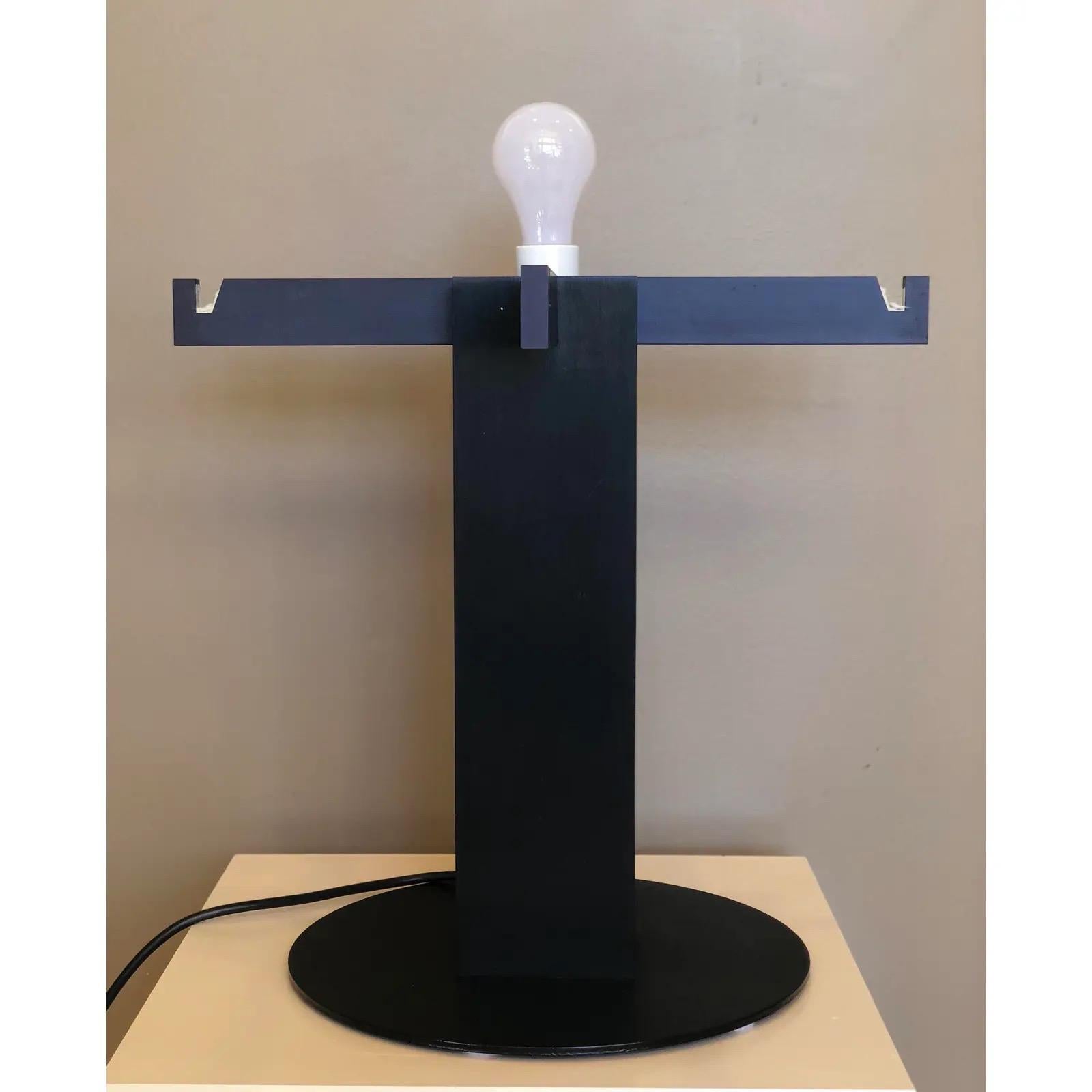 We are very pleased to offer an extraordinary, playful, modernist, table lamp by Californian designer John Rezek, circa the 1980s. This lamp features a black-lacquered metal plinth with four outstretched notched arms that support a heavy