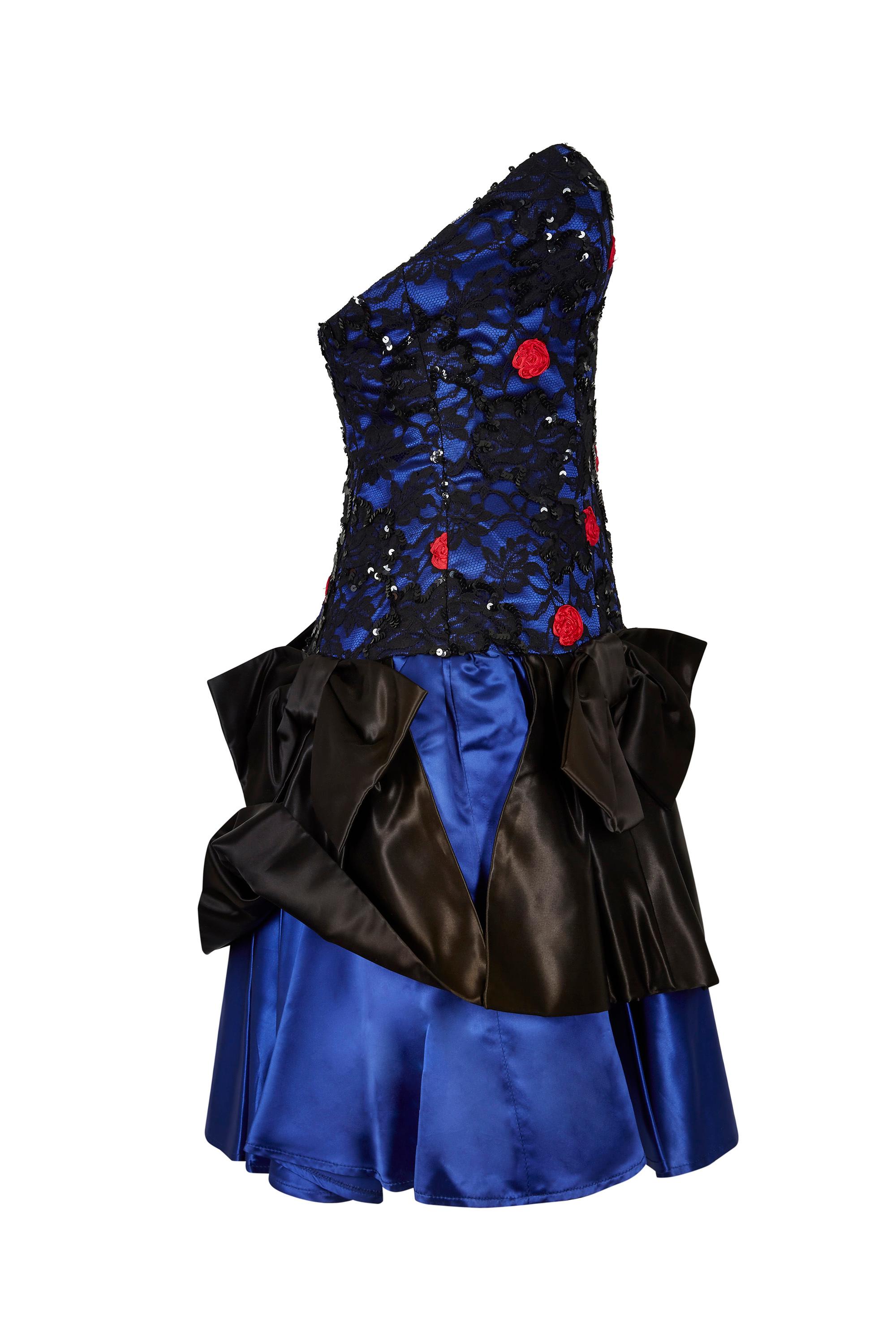 This vivacious late 1980s sateen and lace cocktail dress in cobalt blue is by the famous London boutique Roots and is playful, dynamic and in excellent vintage condition.  Sadly the boutique which was located in fashionable Chelsea, closed its doors