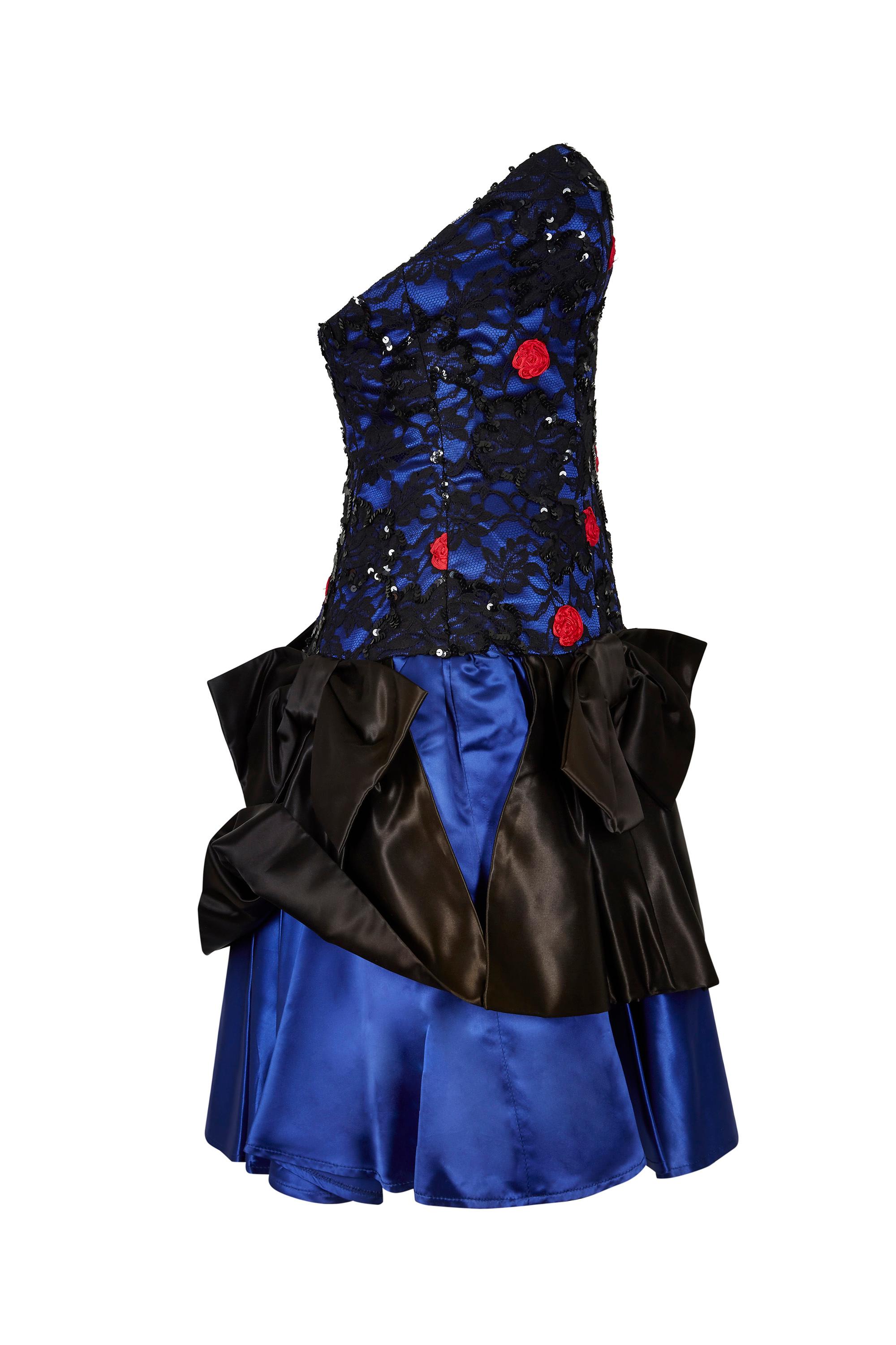 This vivacious late 1980s sateen and lace cocktail dress in cobalt blue is by the famous London boutique Roots and is playful, dynamic and in excellent vintage condition. Sadly the boutique which was located in fashionable Chelsea, closed its doors