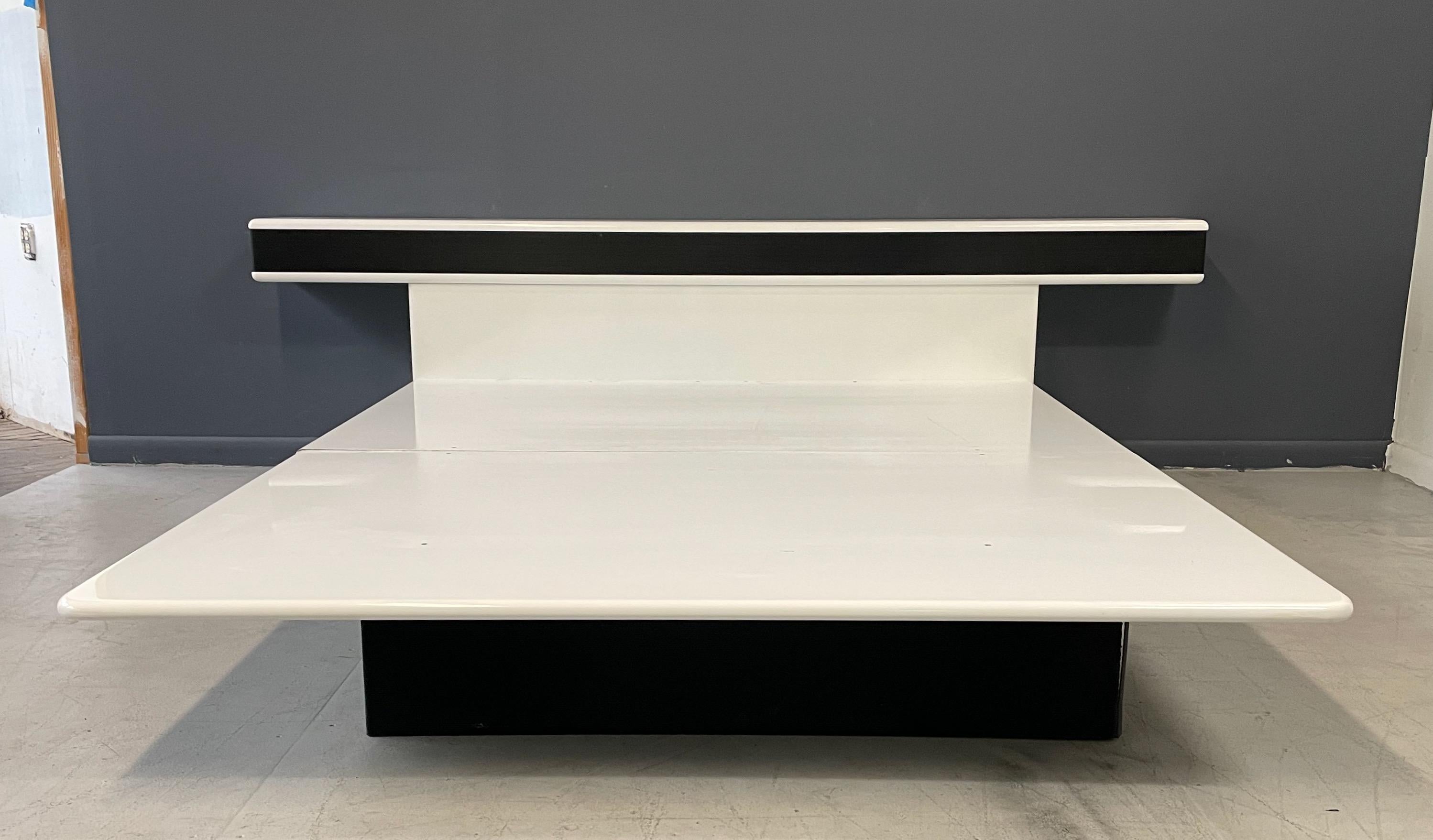Killer postmodern 80s designer platform bed and nightstands designed by Roger Rougier! The Lacquered white pieces have a great space age style featuring an inset black ribbed rubber type material. Very unique!

Bed is queen size. 




