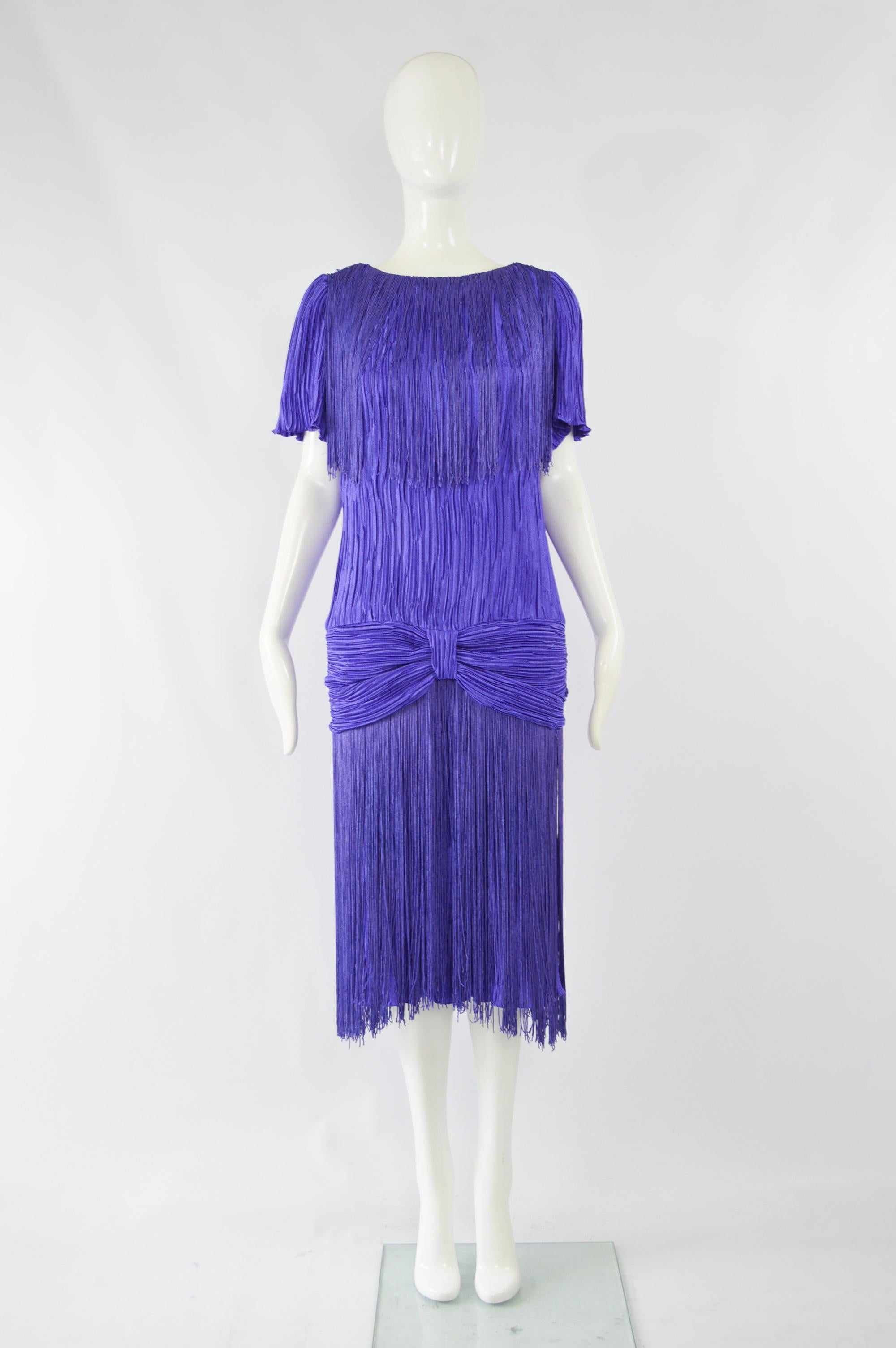 A fabulous vintage womens evening / party dress by high quality American label, Pat Richards. In a royal blue fortuny pleated fabric with a fringed hem and shoulders for a statement look.  

Size: Unlabelled; fits like a UK 14/ US 10/ EU 42. Please