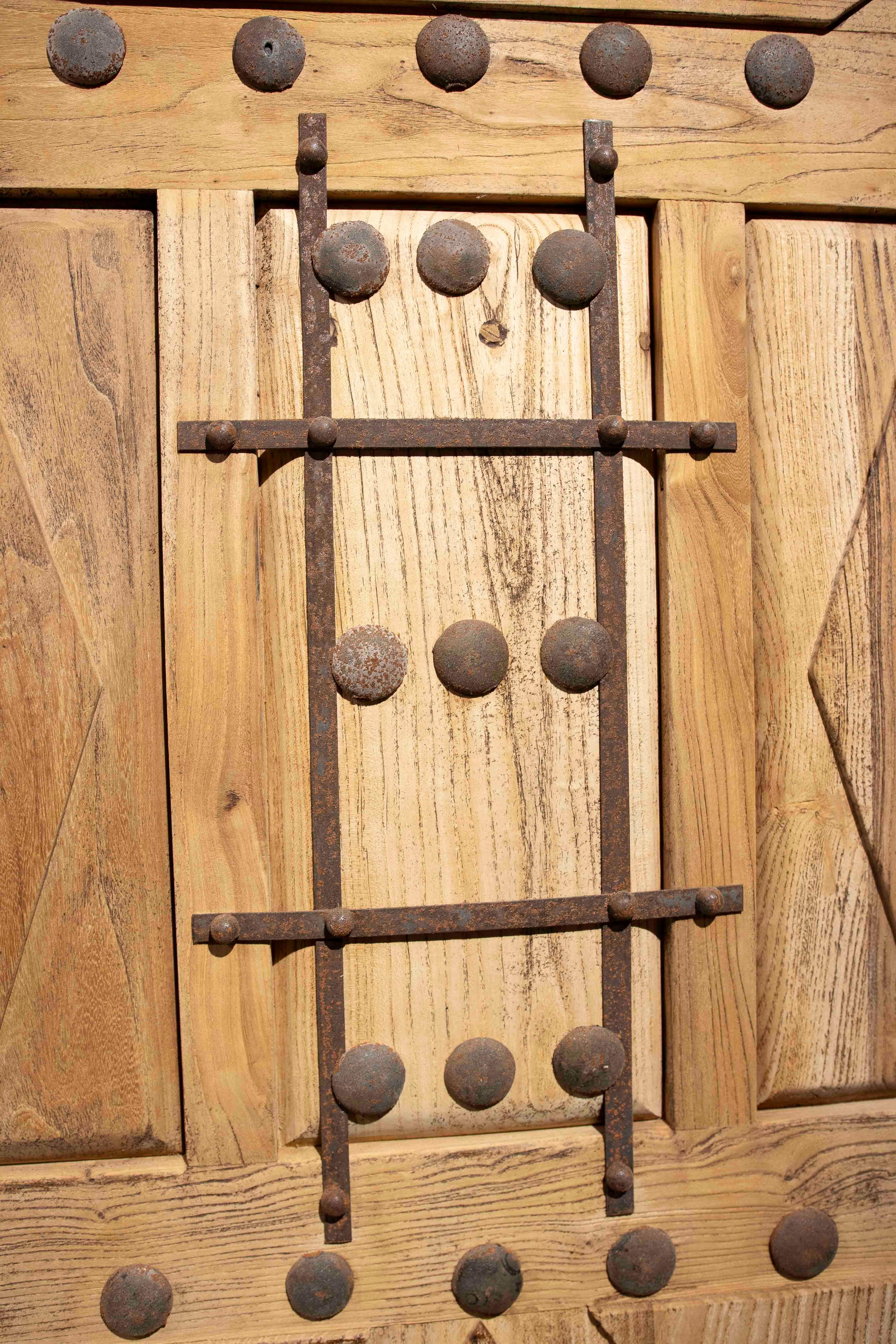 Spanish 1980s Rustic Elm Wood Door with Nails and Decorative Grille For Sale