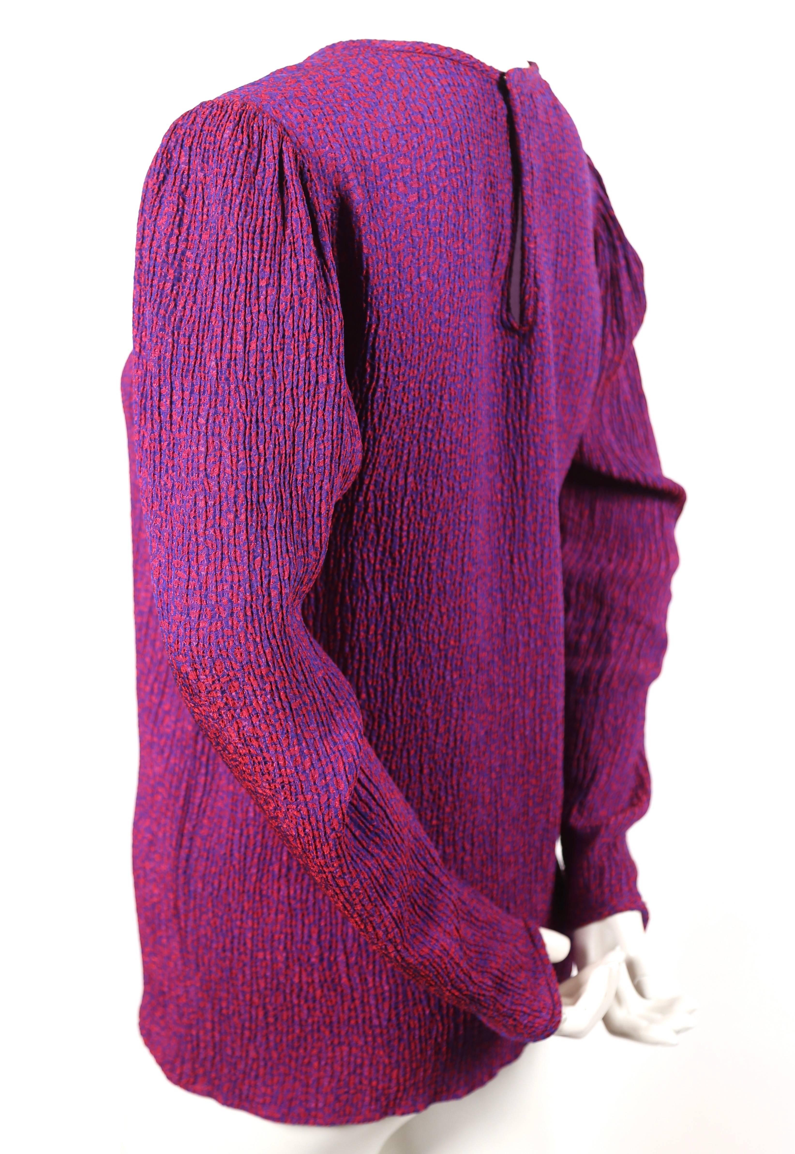 Magenta and purple plisse top with long mutton-style sleeves from Saint Laurent dating to the 1980's. No size is indicated however this best fits a US 4-6. Approximate measurements (unstretched): shoulder 15