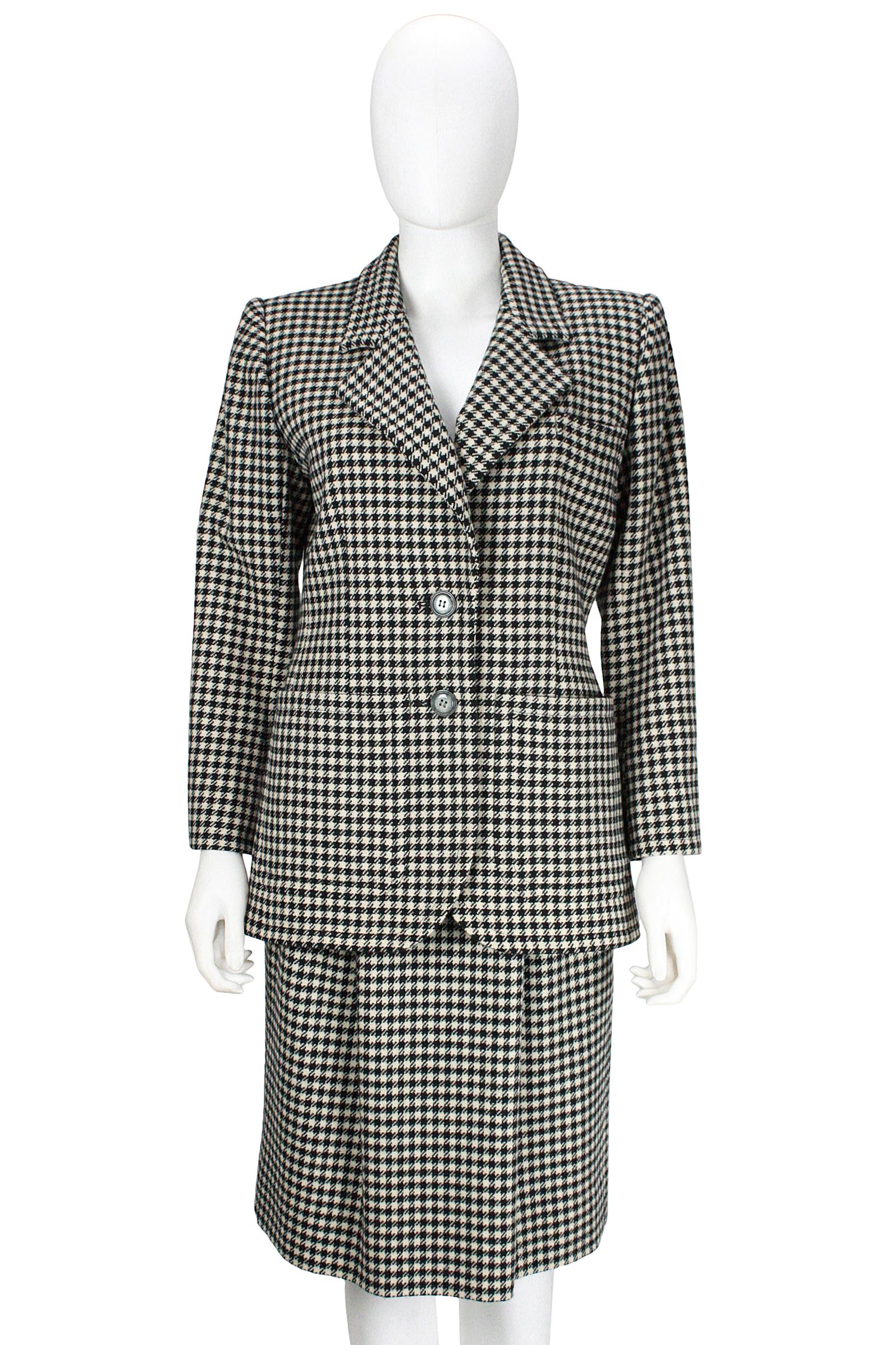 Saint Laurent Rive Gauche 
Wool houndstooth skirt and jacket 
Black and white  
Made in France 
Two lined side pockets 
Two grey buttons 
Black silk lining 
Skirt back vent 
Two skirt side pockets 
Side zipper and hook closure 