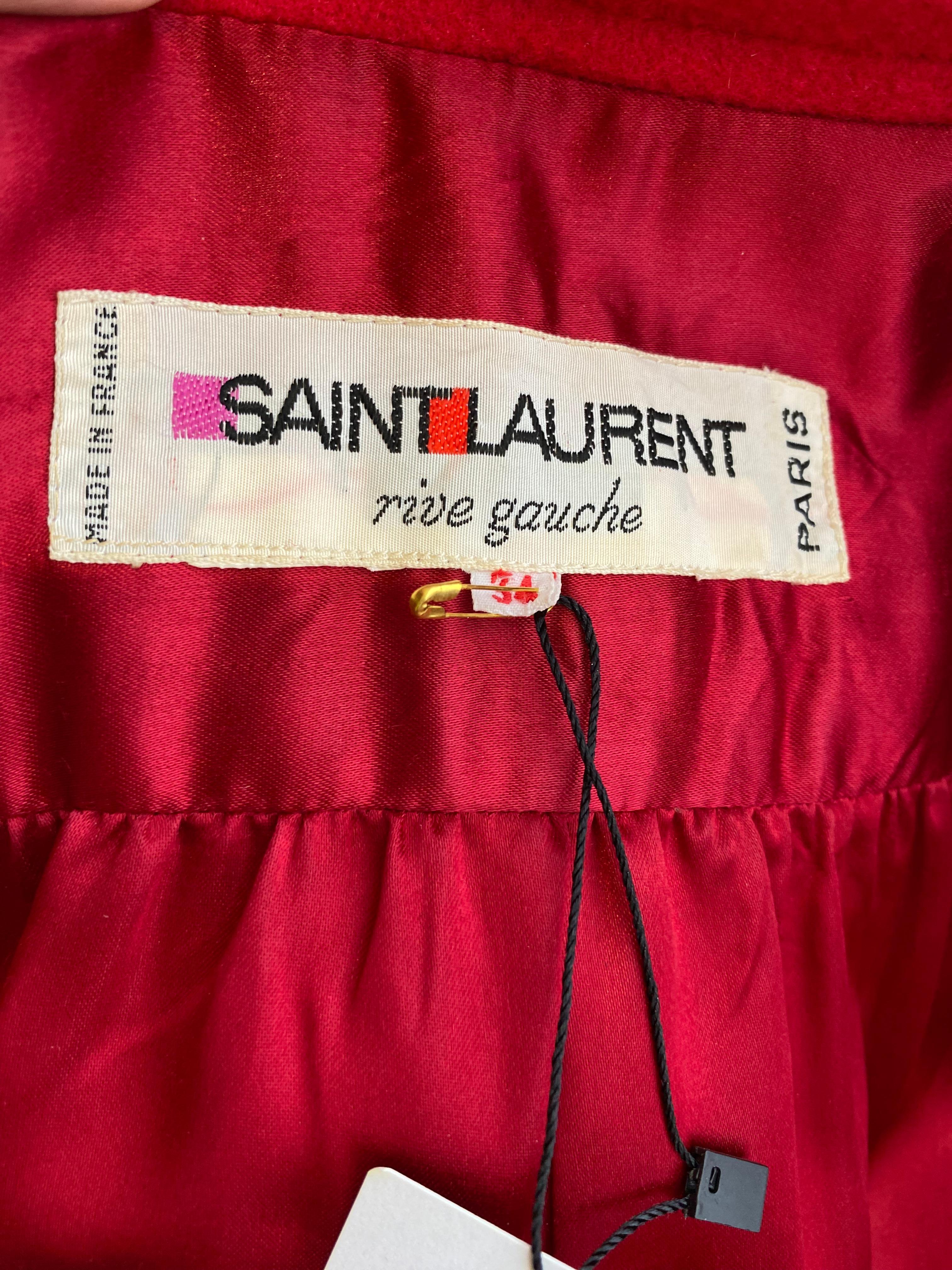 1980s Yves saint laurent red wool coat with belt. 
- mandarin collar
- pockets
- belt
lined in silk
Size 8/ Medium / Marked size 34Fr
Bust 40”

** flaws ( see image ) attached lining need to be re stitch and tiny holes on the fabric