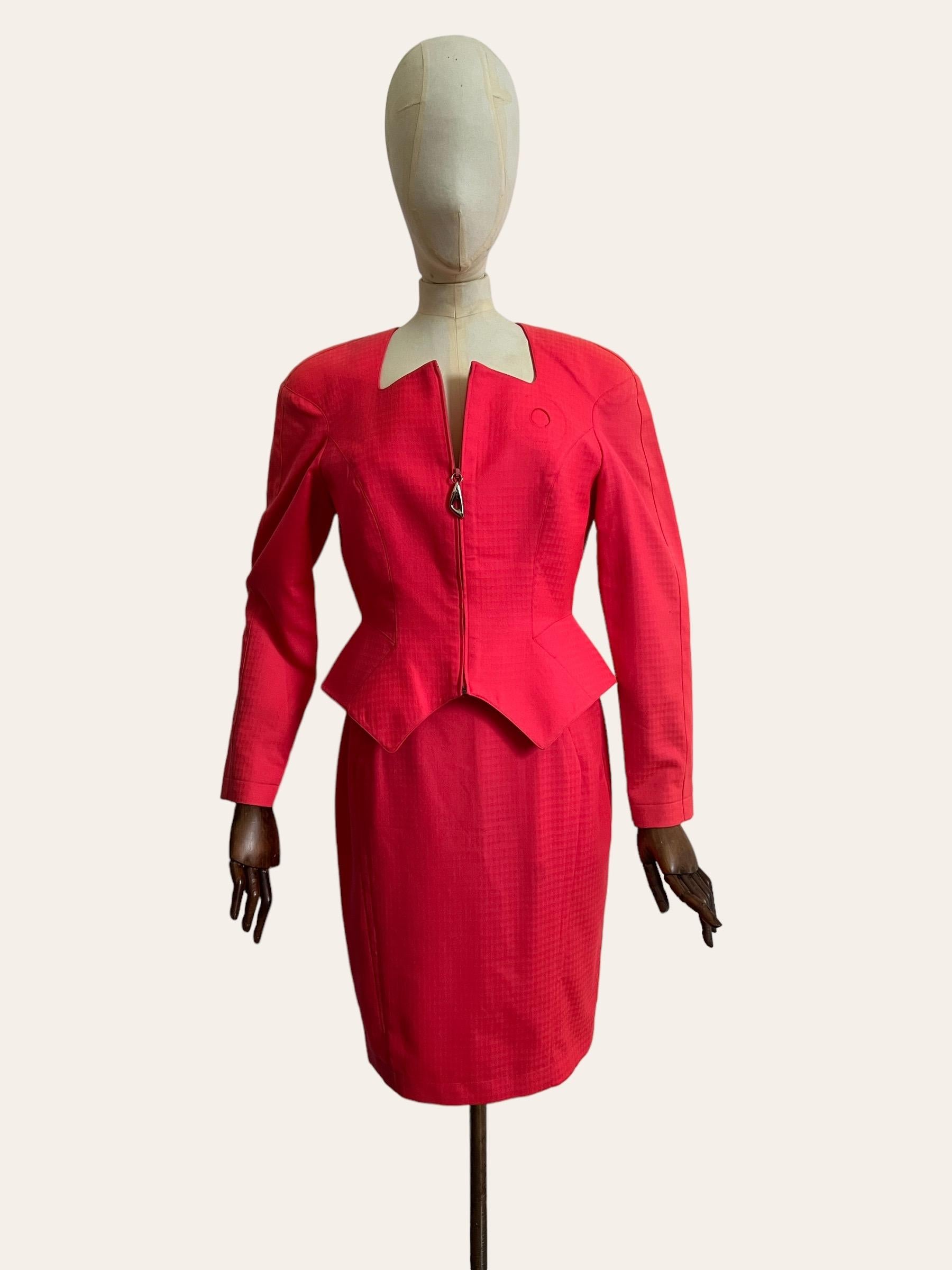 Vintage 1980's Thierry Mugler Skirt and Jacket Suit.

This Iconic Set features a fitted, nipped waist Jacket with statement padded shoulders and matching high waisted fit pencil skirt. Both garments are fully lined and have Zip fasten closures.

The