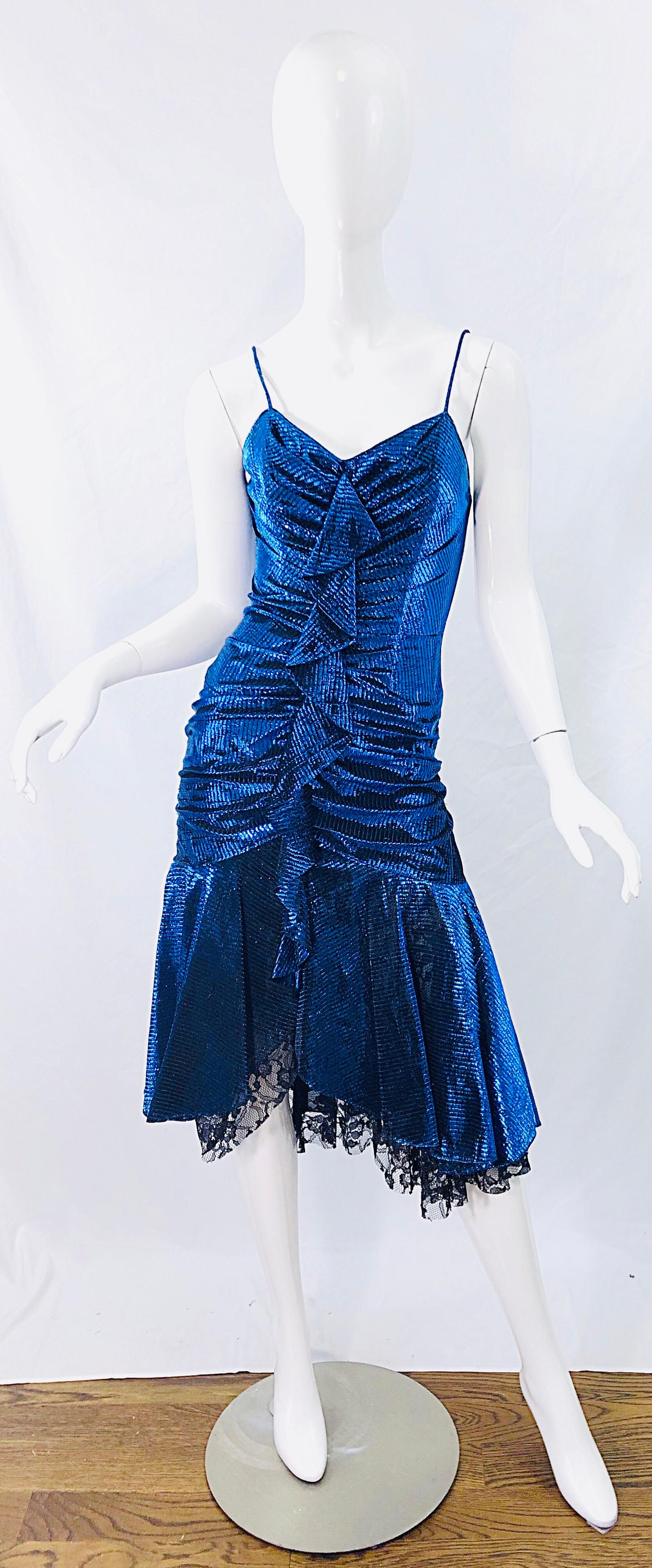 Sexy 1980s SAMIR metallic electric blue lurex and black lace handkerchief hem slinky spaghetti strap dress ! Features a flattering ruched body, with a ruffle down the center. Innner boning keeps everything in place. Hidden zipper up the back. Looks