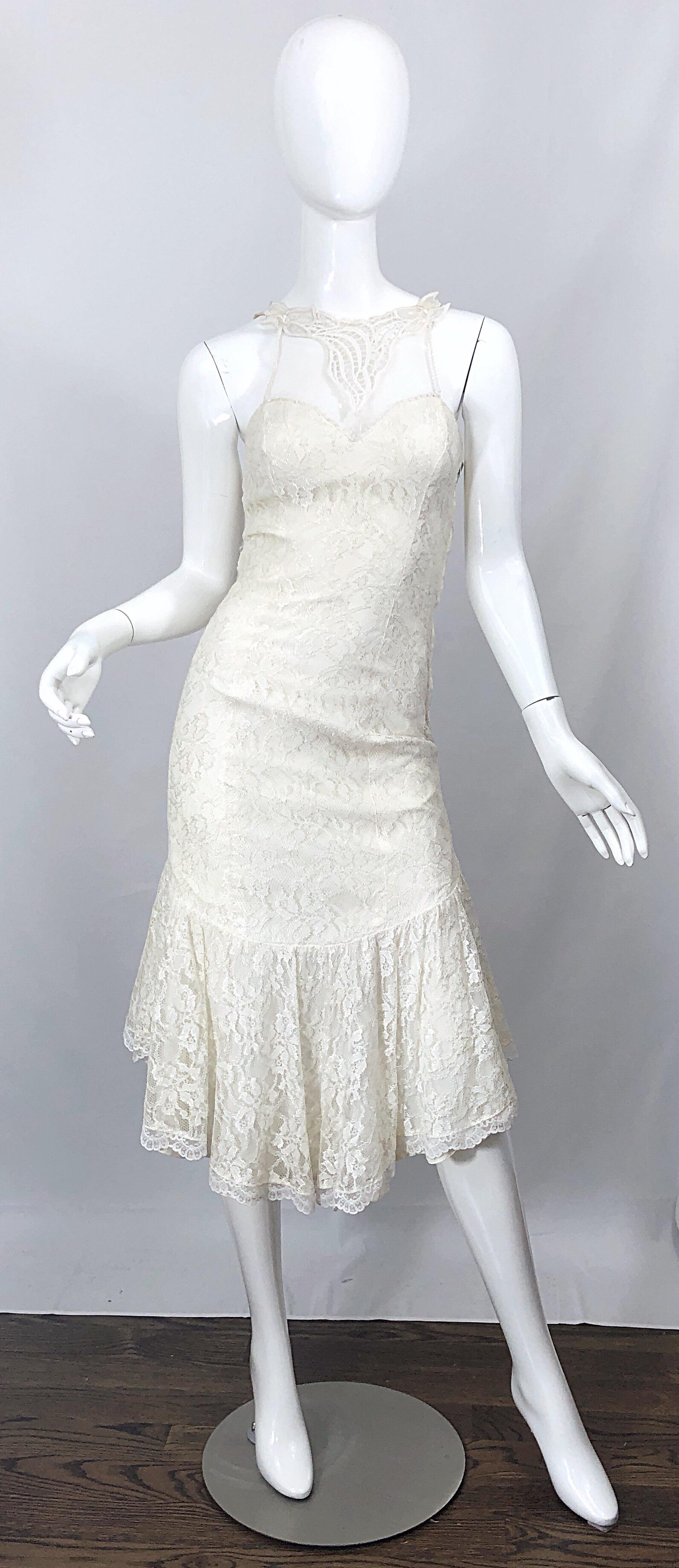 Fabulous 1980s SAMIR ivory / white lace embroidered handkerchief hem cocktail dress! Features a sweetheart neckline with a mesh embroidered overlay above the bust. Satin bow at center back, just above the rear. Hidden zipper up the back with