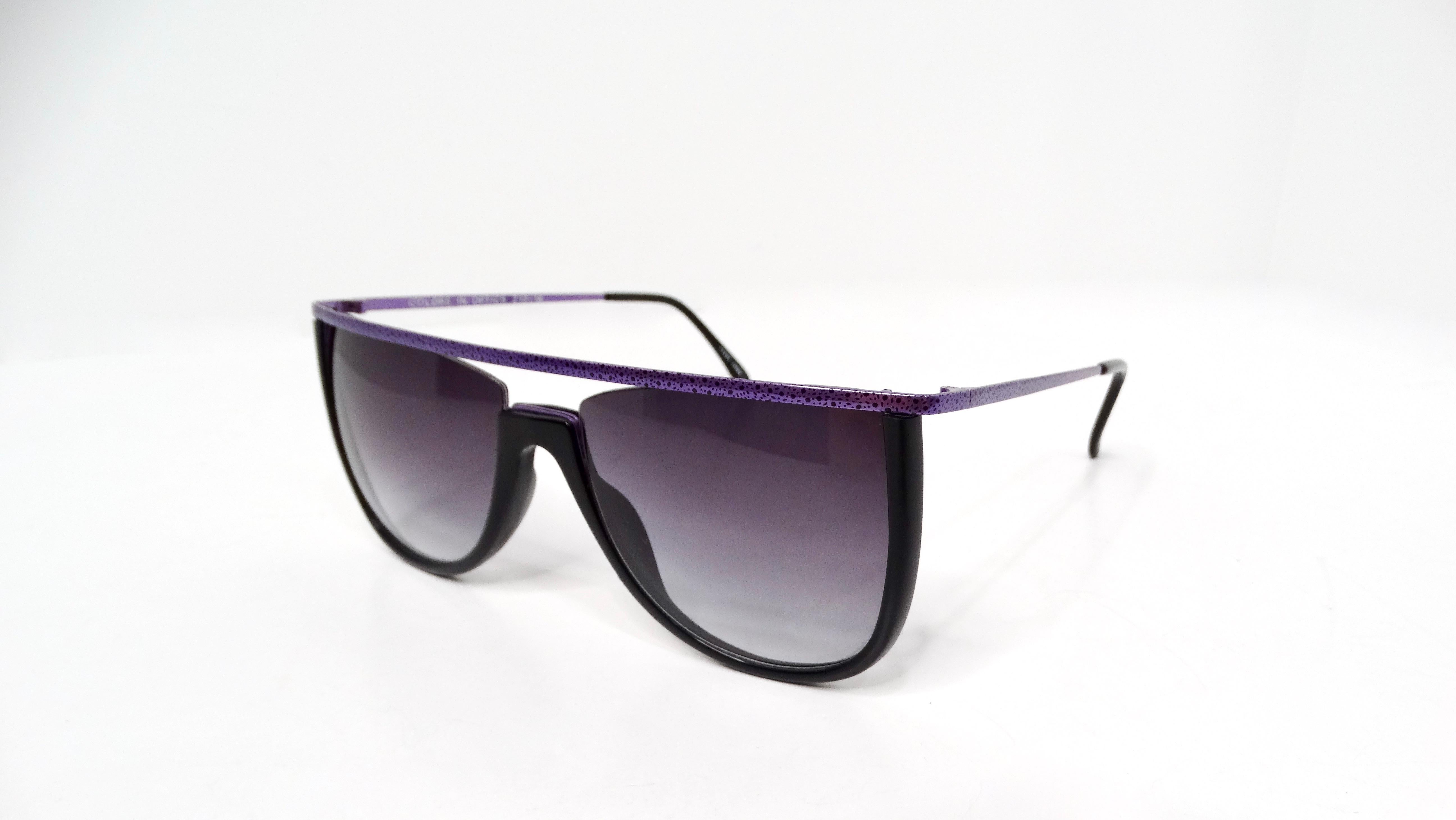 These iconic 1980s Sanford Hutton Purple & Black Leopard Print Metal Frame Sunglasses embody the daring aesthetic of the era, featuring a striking purple top bar accentuated with a bold black spotted leopard print motif on both the frame and the