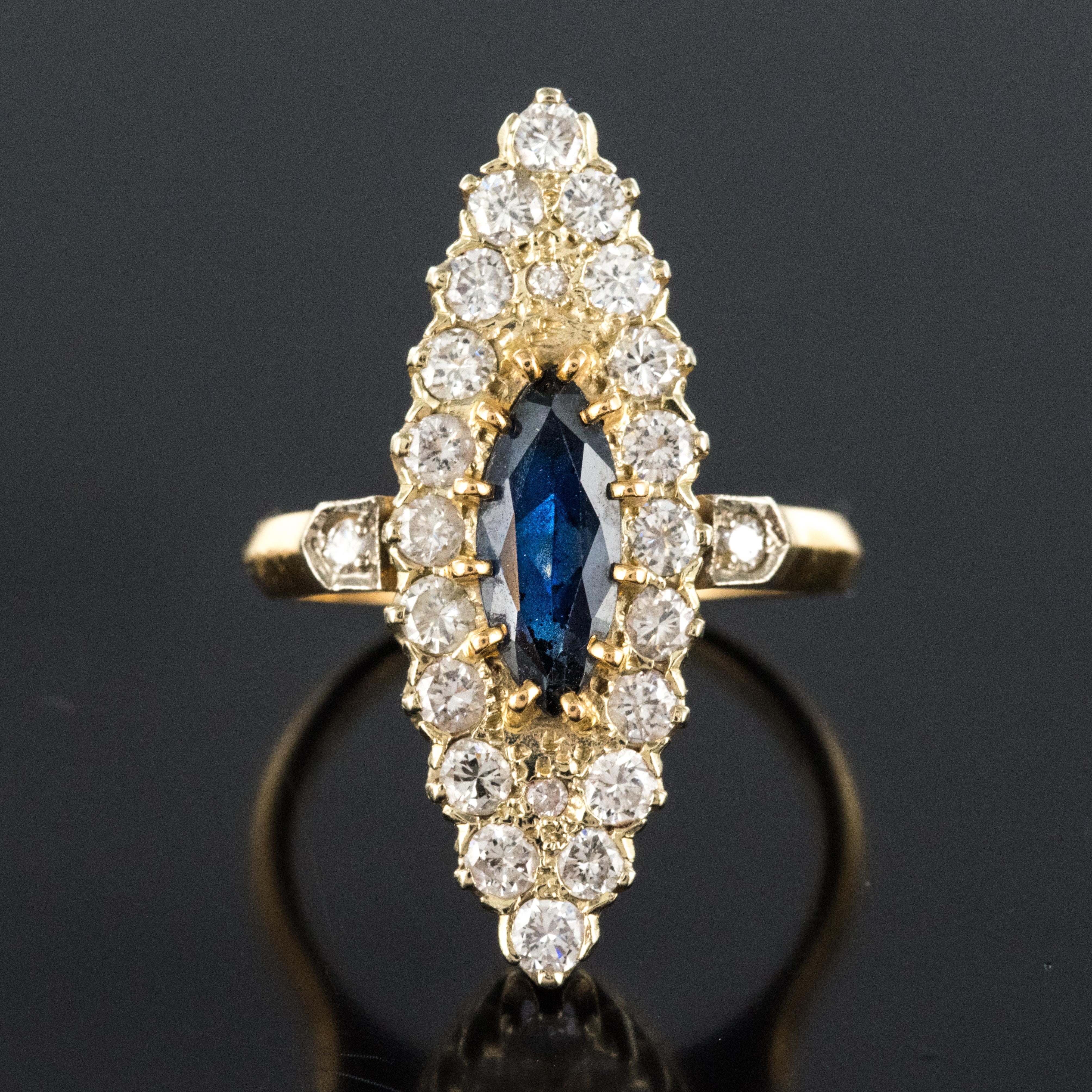 Ring in 18 karats yellow and white gold, eagle's head hallmark.
Marquise shape, this retro ring is adorned on its top with an intense blue sapphire, shuttle size. It is surrounded by brilliant- cut diamonds. On both sides, the start of the ring is