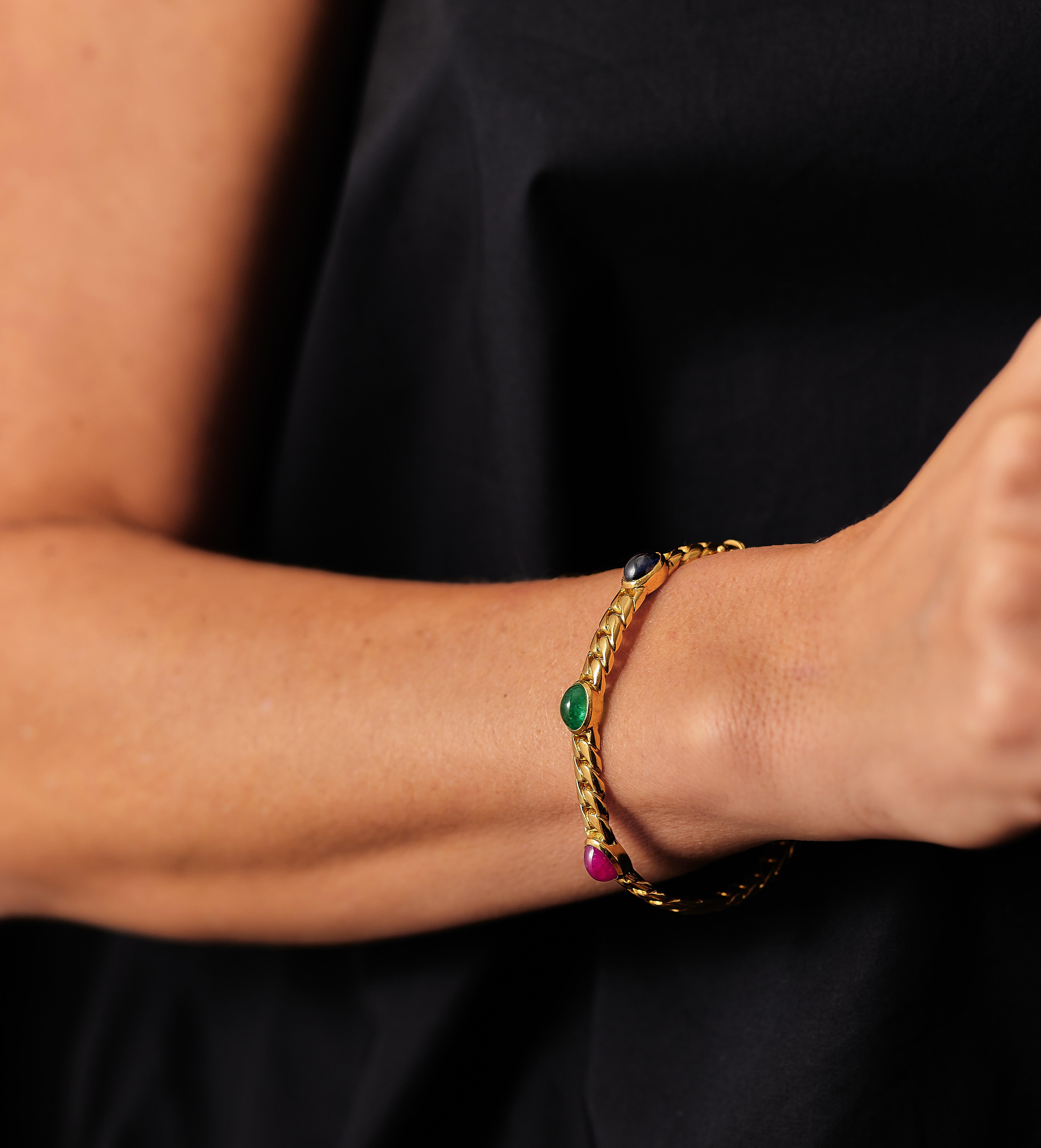 Classic for a reason. 
Curb link bangle, set with 3 cabochon cut natural stones, emerald, sapphire and ruby with a total weight of approximately 6.96ct. The stones are of high quality and have a beautiful color. 

The bracelet is Signed VG and
