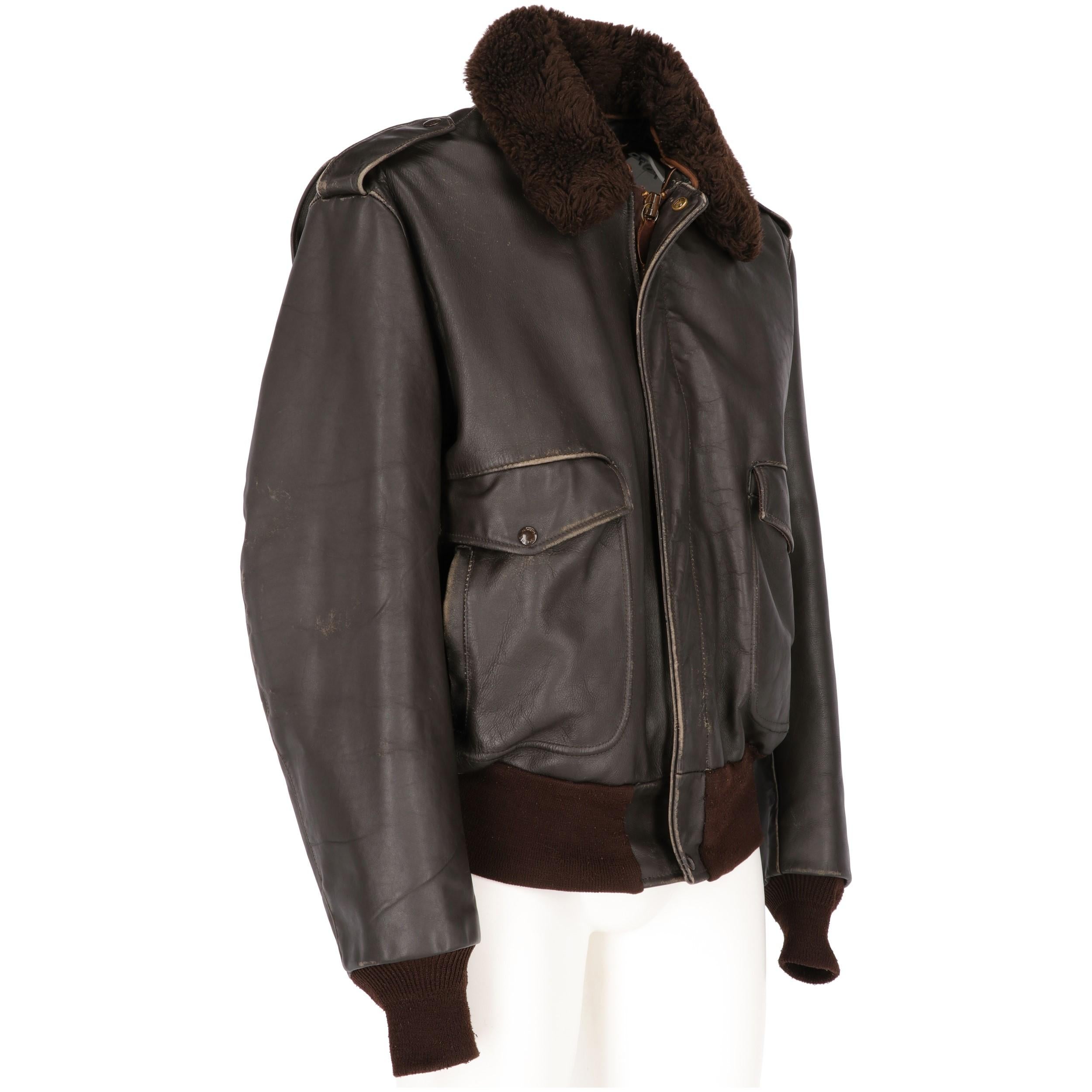 Schott USA dark brown genuine leather jacket with removable fake fur collar, epaulettes with press studs, lightly puff sleeves and ribbed elastic brown cotton cuffs, front fastening with bronze-tone metal thick zip and leather puller, one press stud