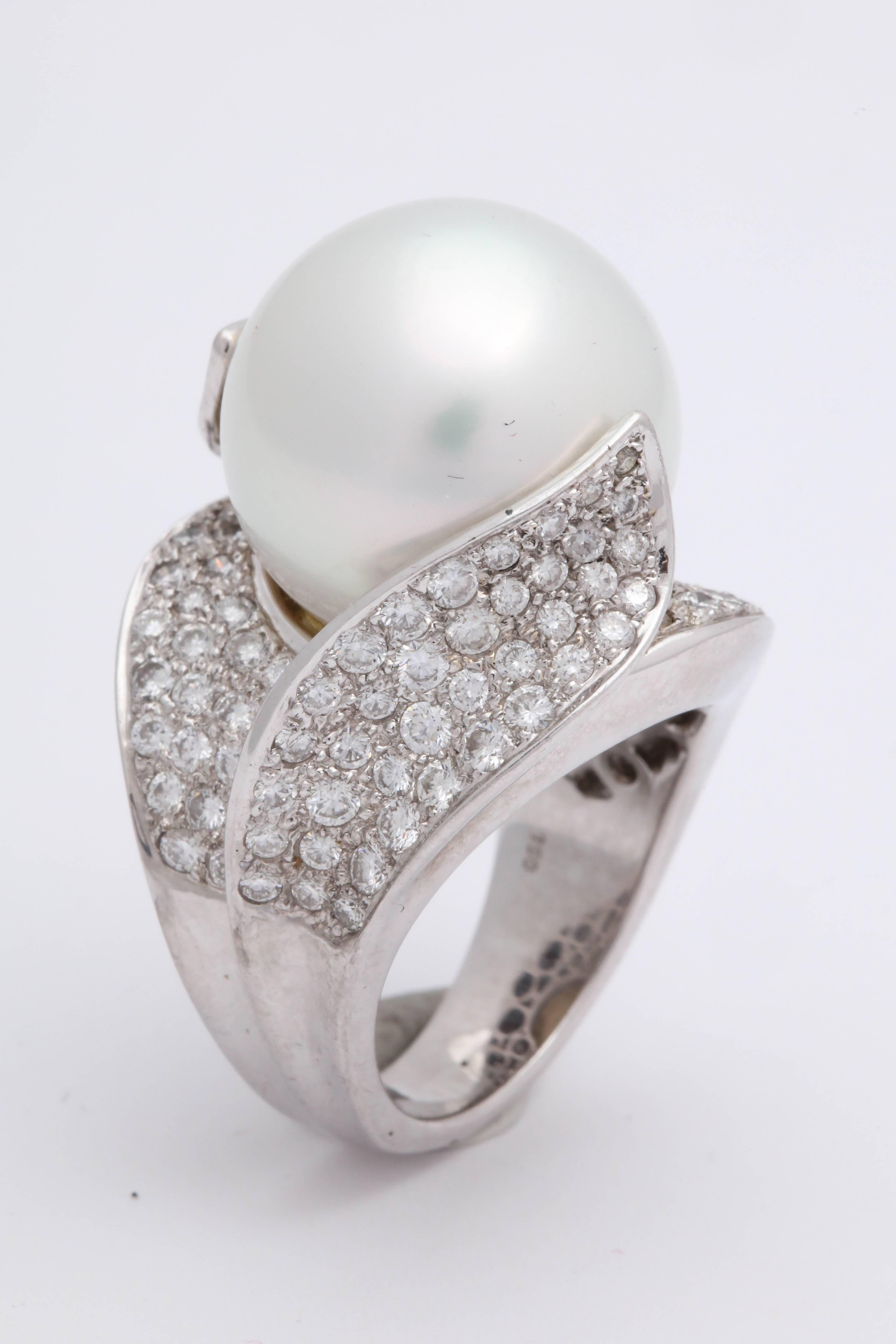 One Ladies Cocktail Style Ring Created In 18kt White Gold Embellished With Numerous Full Cut Diamonds Weighing Approximately 3 Carats Total Weight. Dome Ring Is Centering A Large Beautiful Color And Luster High Quality 17MM White South Sea