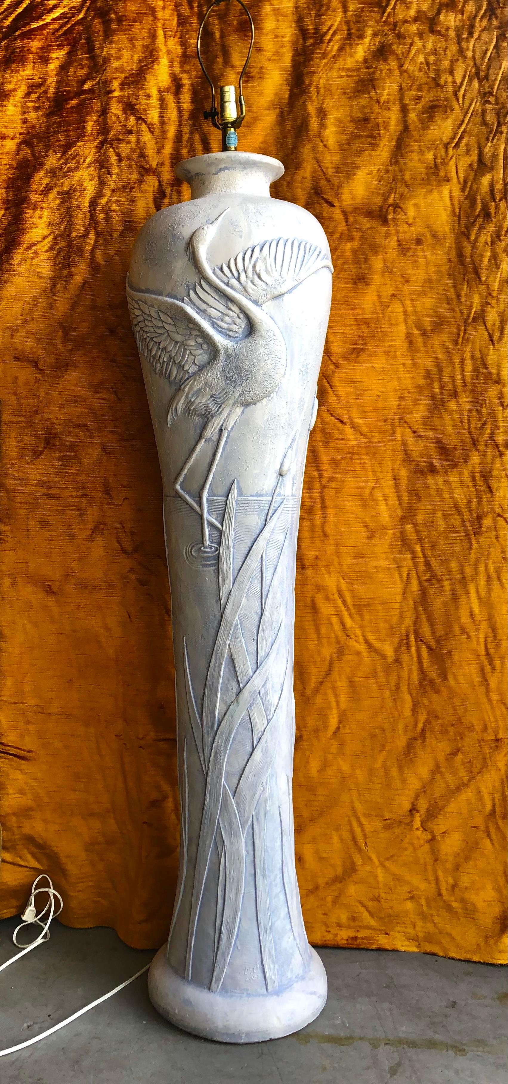 Sculptural Coastal / Hollywood Regency style florida herons plaster three way floor lamp. Circa 1980s.
Hand Signed / Carved by the Artist. 
Features a sculptural molded plaster amphora shaped body with two Florida blue herons and aquatic foliage