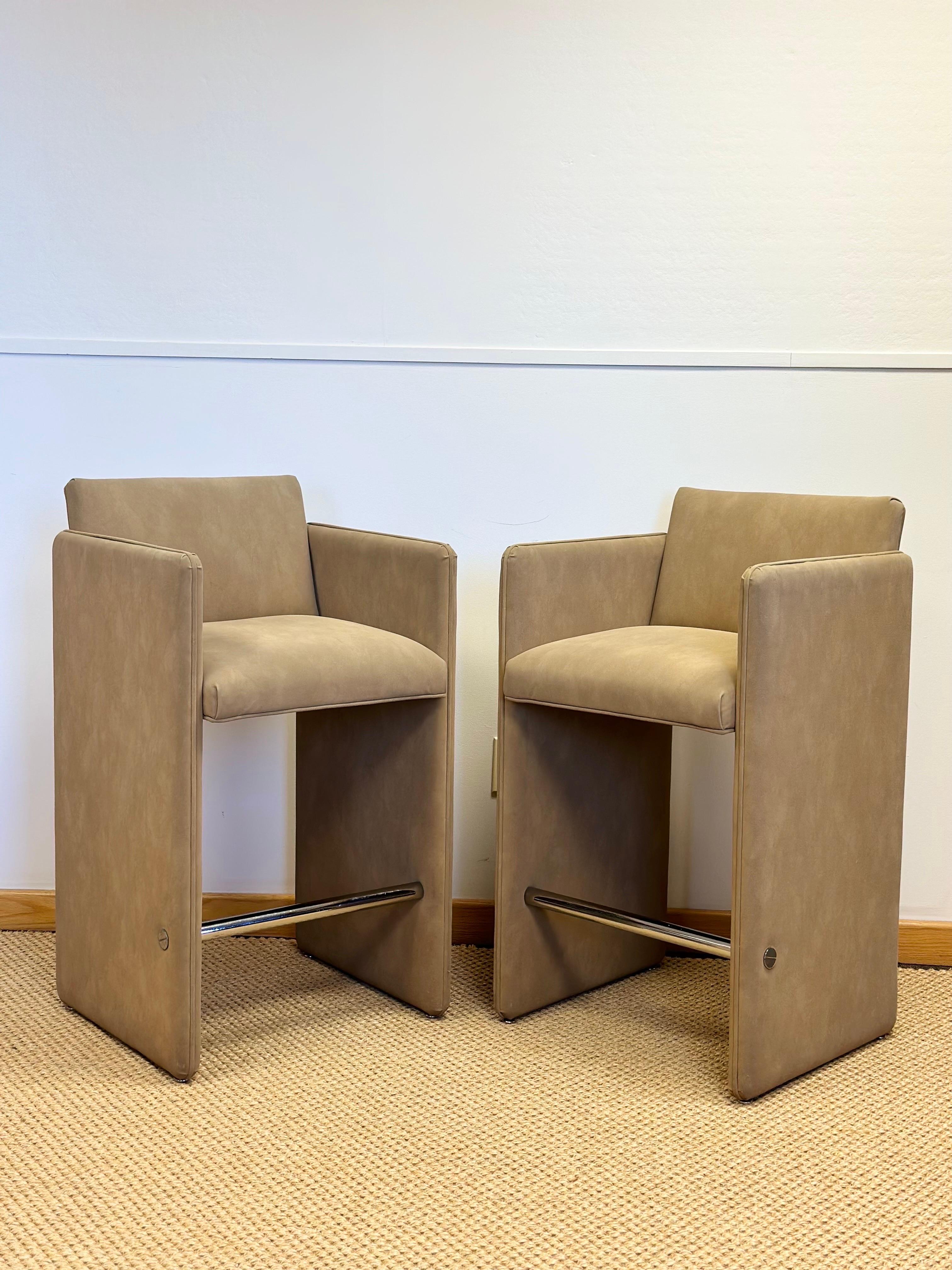 We are very pleased to offer a stylish, unique pair of bar stools, circa the 1980s.  These vintage barstools are a nod to Italian postmodernism, showcasing a distinct architectural presence.  Influenced by classical proportions and timeless design