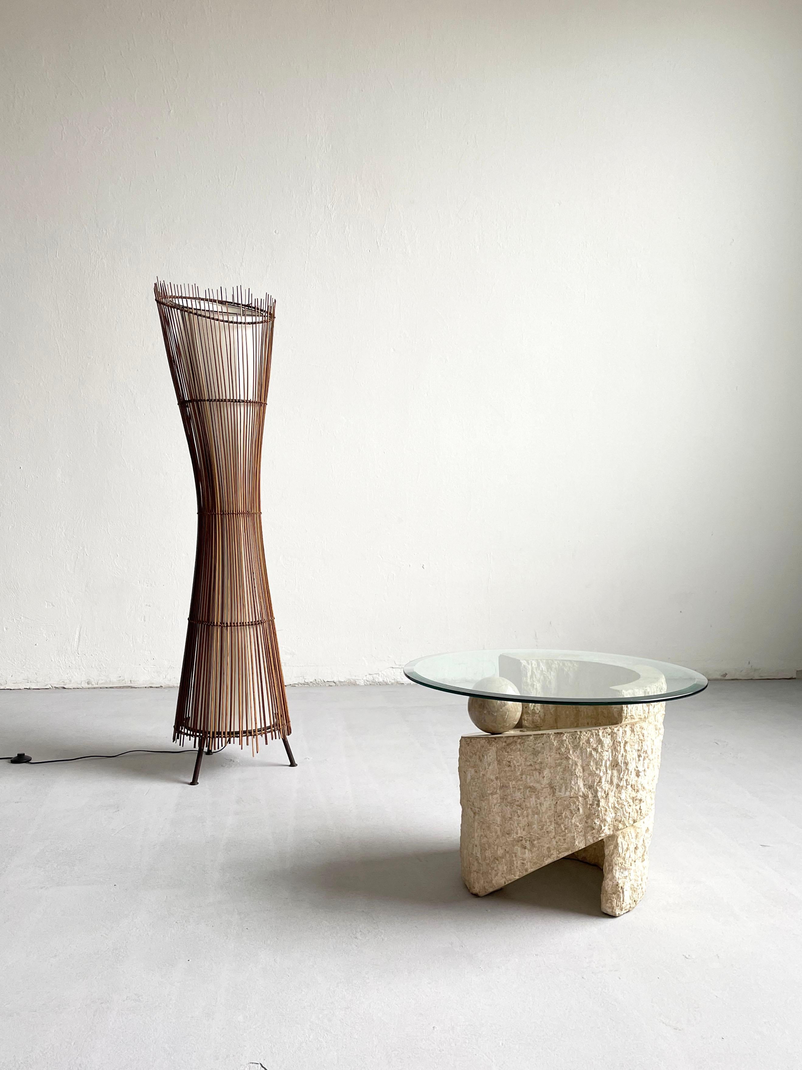 Vintage Postmodern sculptural accent or end table made of mactan stone with a freestanding clear glass top

Manufactured in the 1980s

The base of the table has an asymmetrical spiral shaped organic form with a contrasting textures of rough and