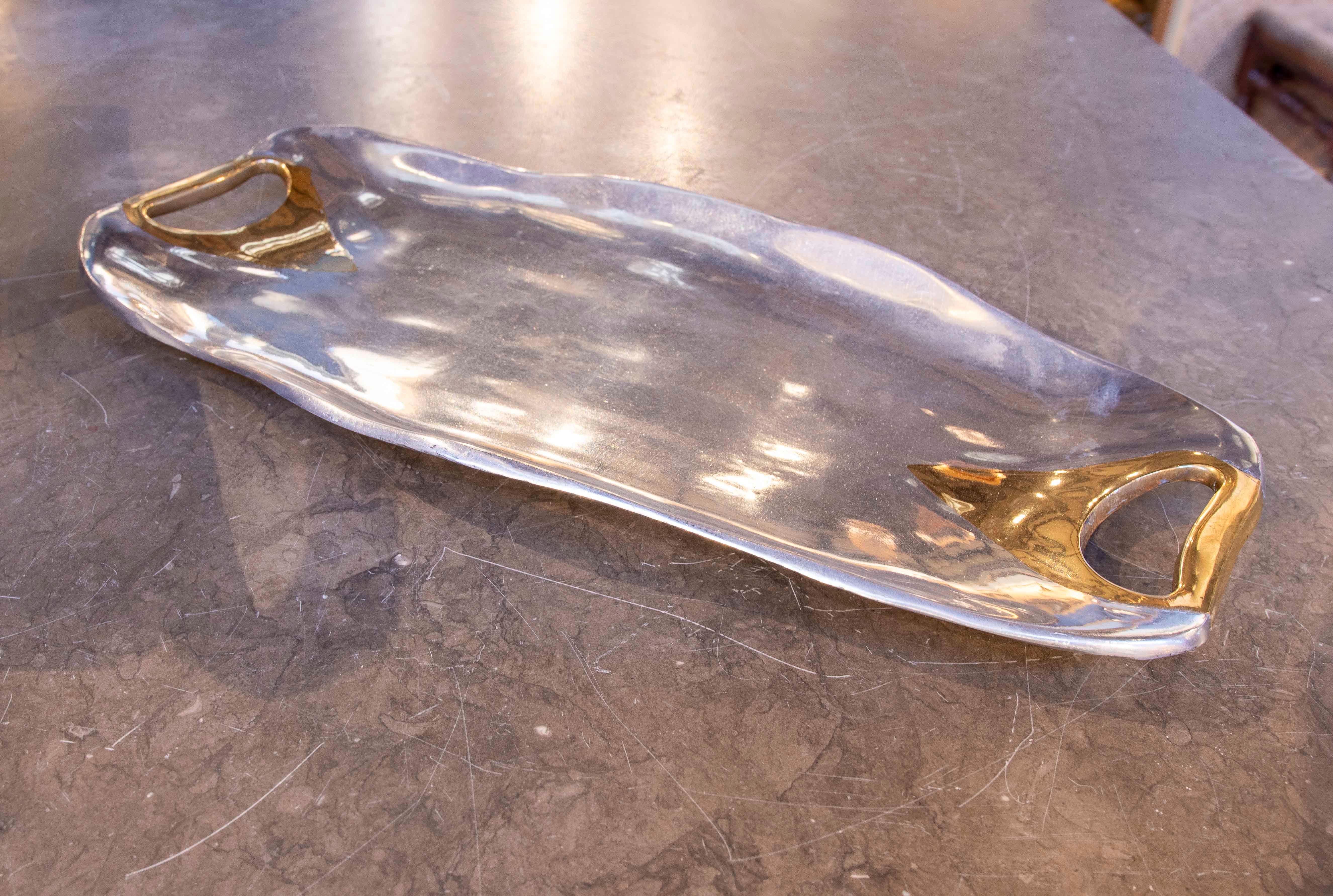 Elegant tray designed by renowned artist David Marshall, crafted in hammered bronze with polished brass handles that add a sophisticated touch. Its fluid, minimalist design combines functionality and artistry, making this piece an ideal accessory