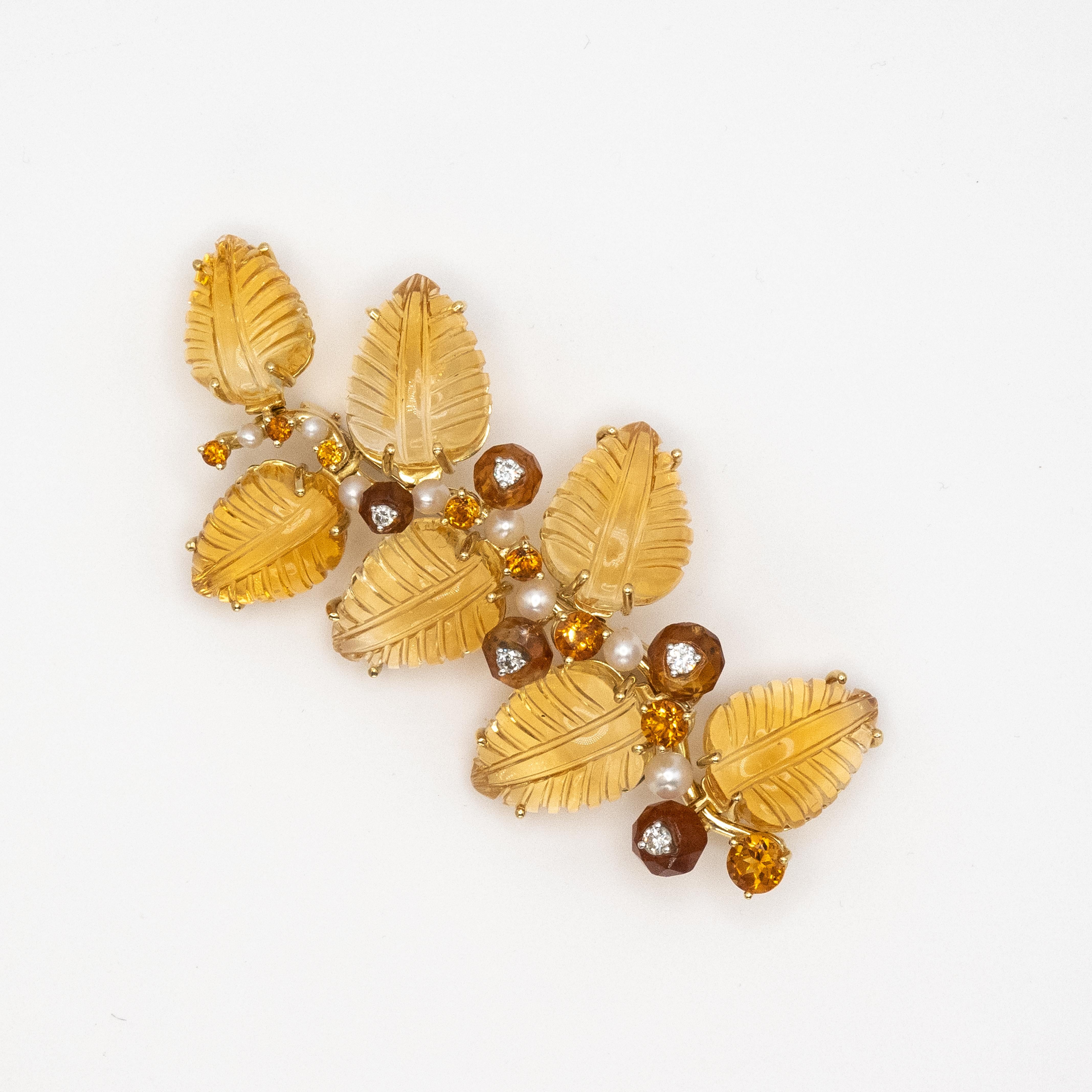 Stunning Seaman Schepps 18K yellow gold citrine brooch set with diamonds & 7 carved citrine leaves. Along the vine of leaves are 5 diamonds in E-F color & VS-SI clarity, 5 facet cut citrine beads, 8 round cut citrines.

Approximate Weight:  47.1