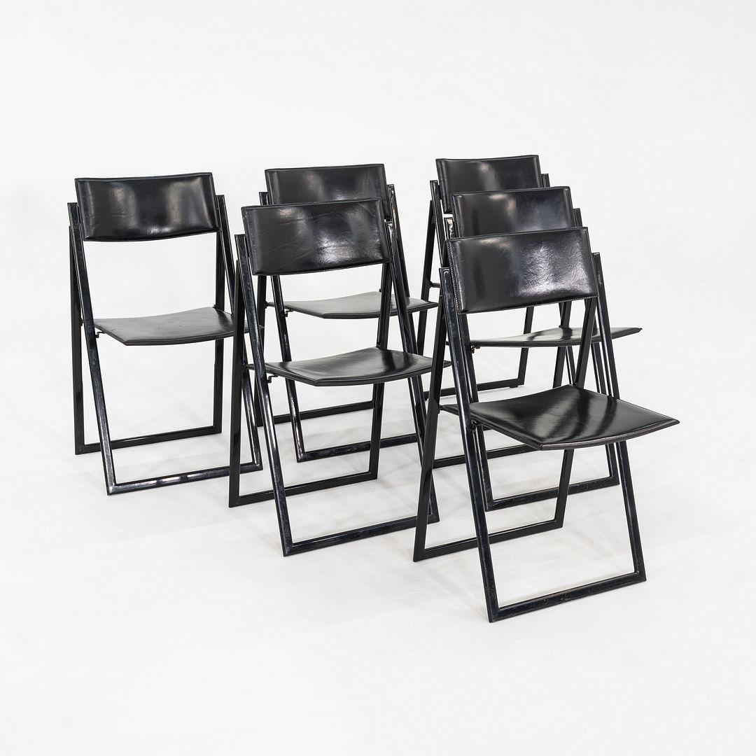 These is a Set of Six Garina Folding Dining Chairs, designed by A. Ricciardi and G. Salvini for Matteo Grassi. These examples were produced in the 1980s, and the listed price includes the set of six as shown. Their design features a black enameled