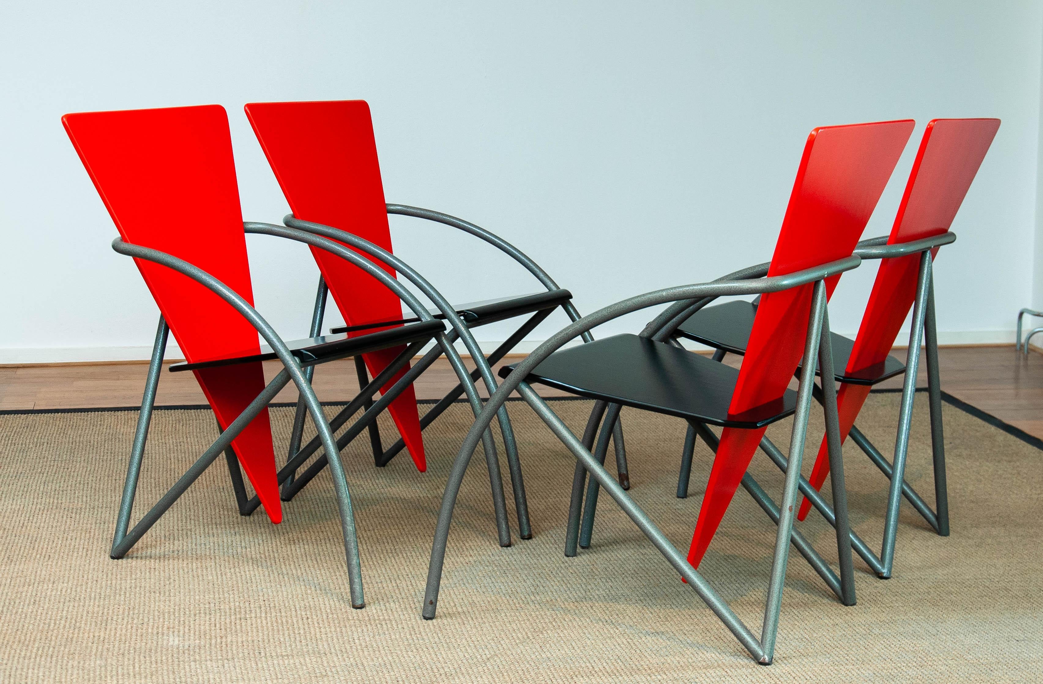 This striking set of four 1980s dining chairs by Klaus Wettergren showcases a bold and modern design. Featuring vibrant red triangular backrests and sleek black seats, these chairs create a dynamic contrast that embodies postmodern aesthetics. The