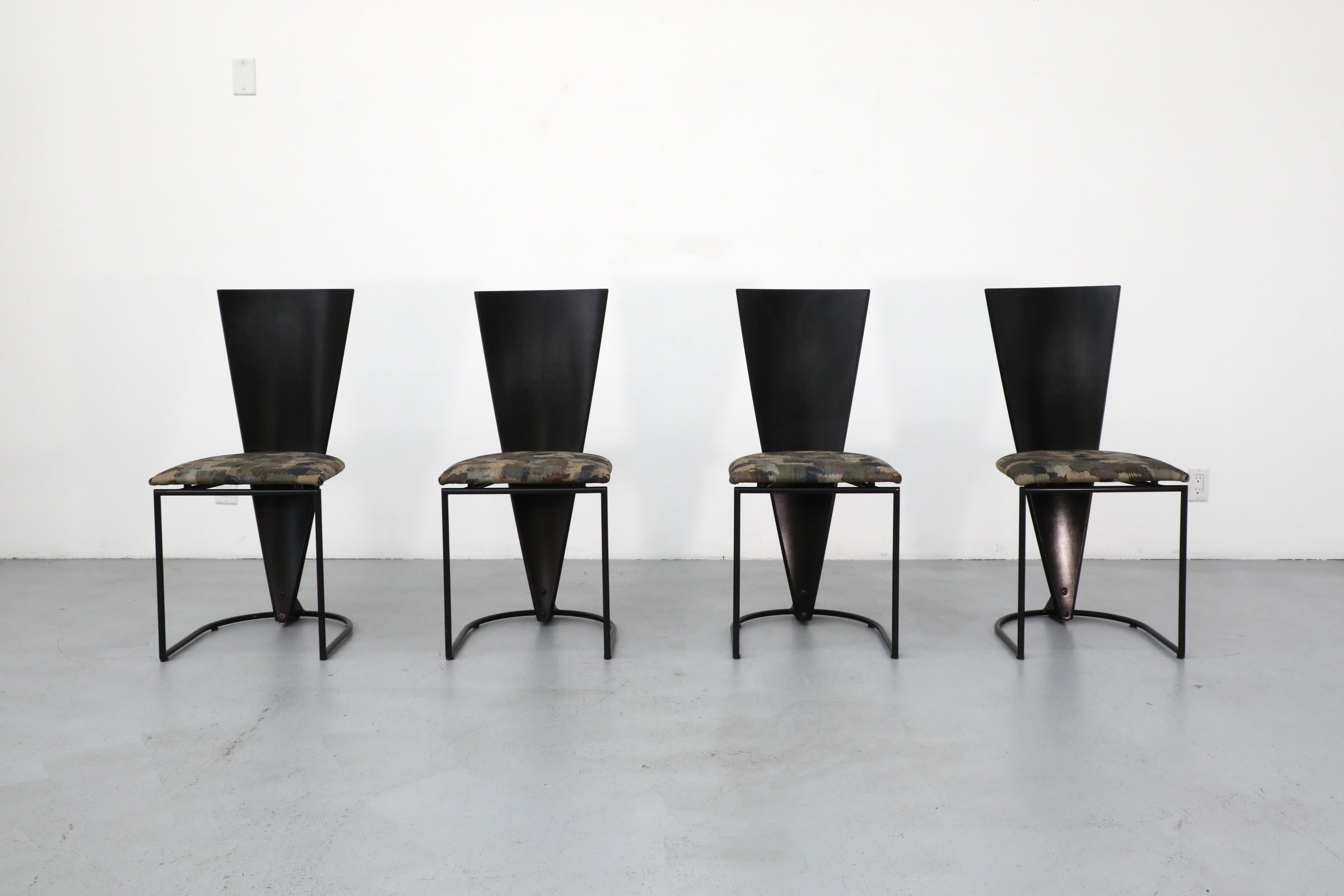 Memphis style tall black painted wooden triangle-back dining chairs with original fabric seats on black metal enameled frames. In original condition with some wear and scratching consistent with age and normal use.