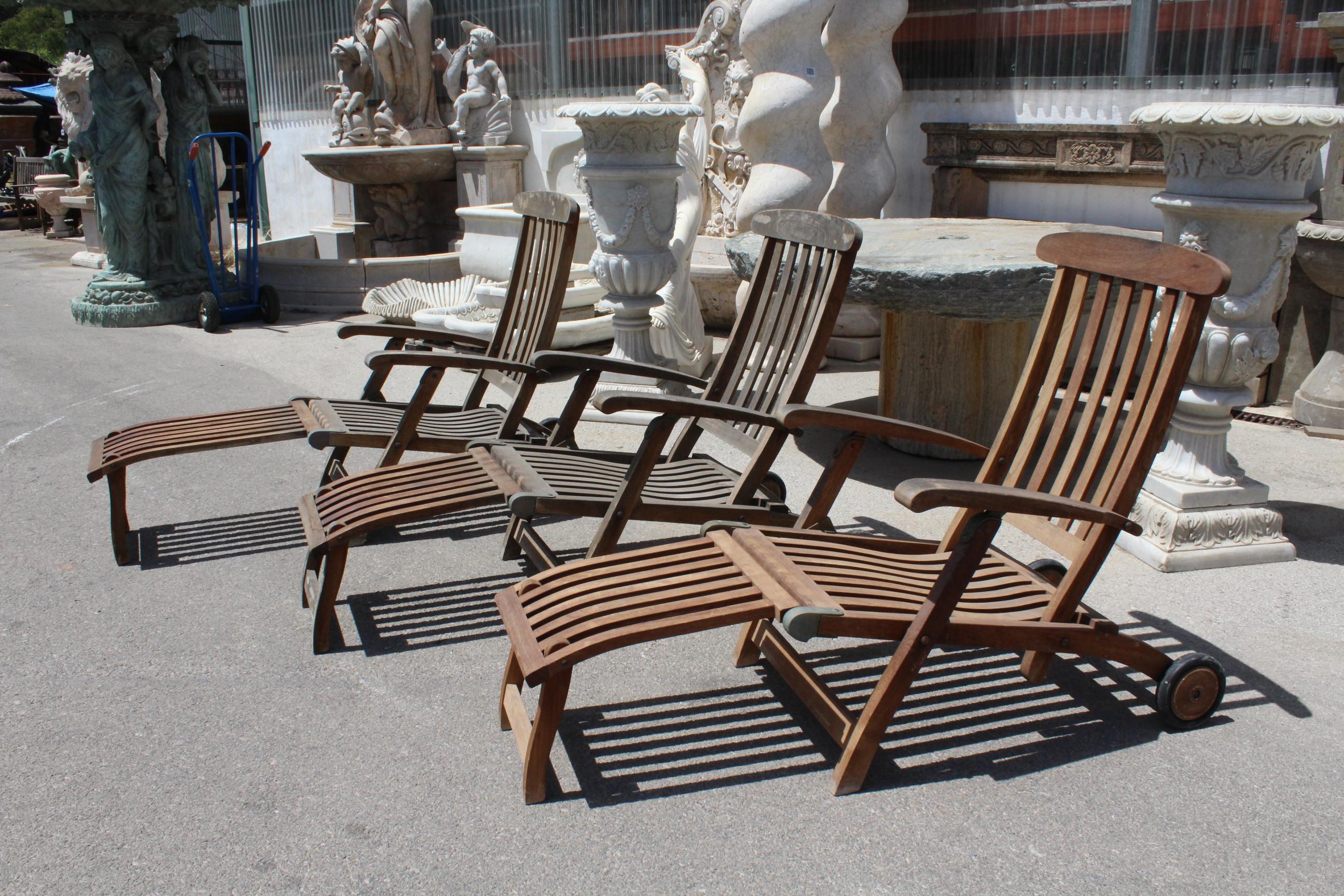 1980s set of three English teak wood loungers with bronze hinges.
   