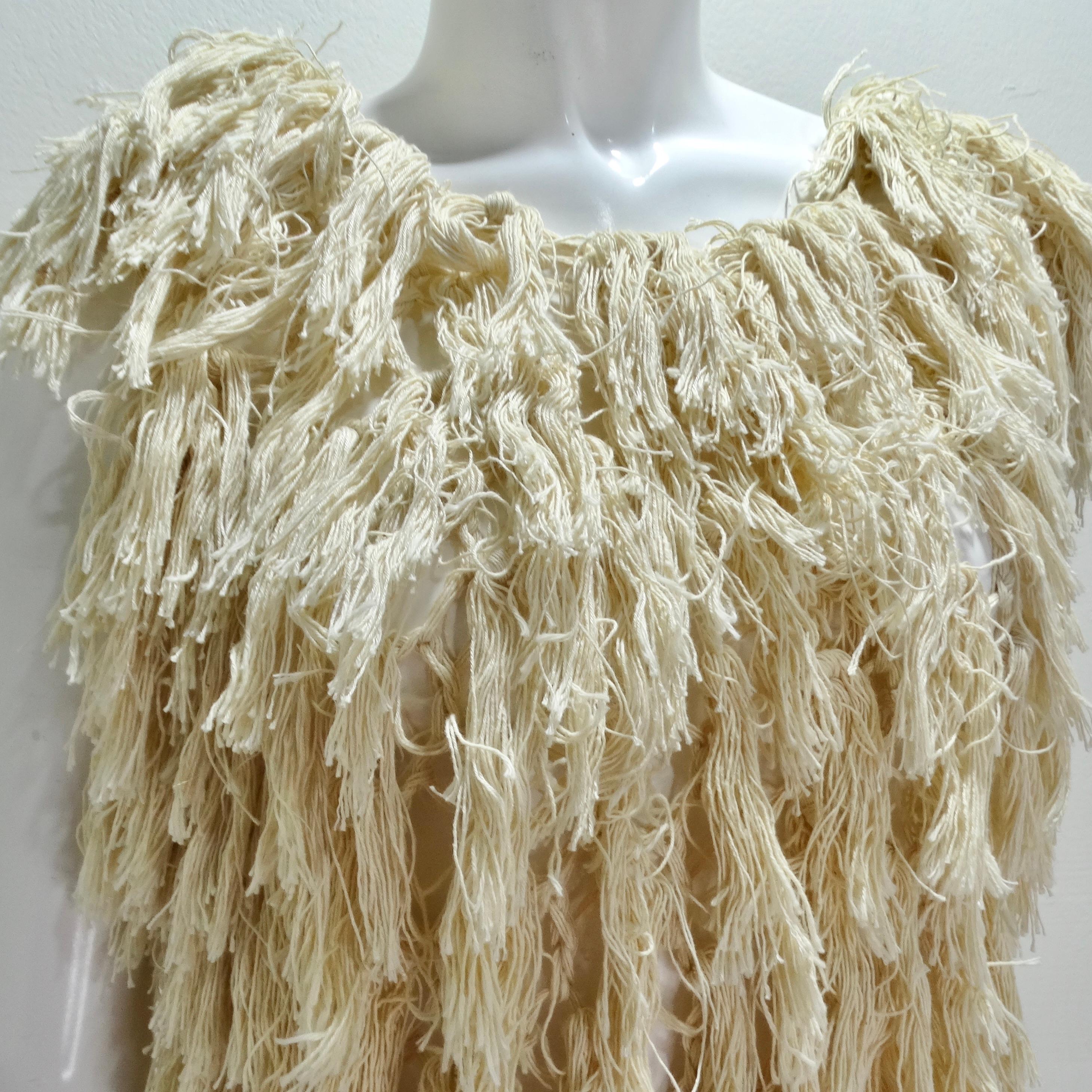 Introducing the 1980s Shaggy Fringe Knit Top – a distinctive and playful statement piece that effortlessly captures the spirit of the '80s with its shaggy fringe and unique 3D effect. This neutral off-white knit top is a versatile addition to your