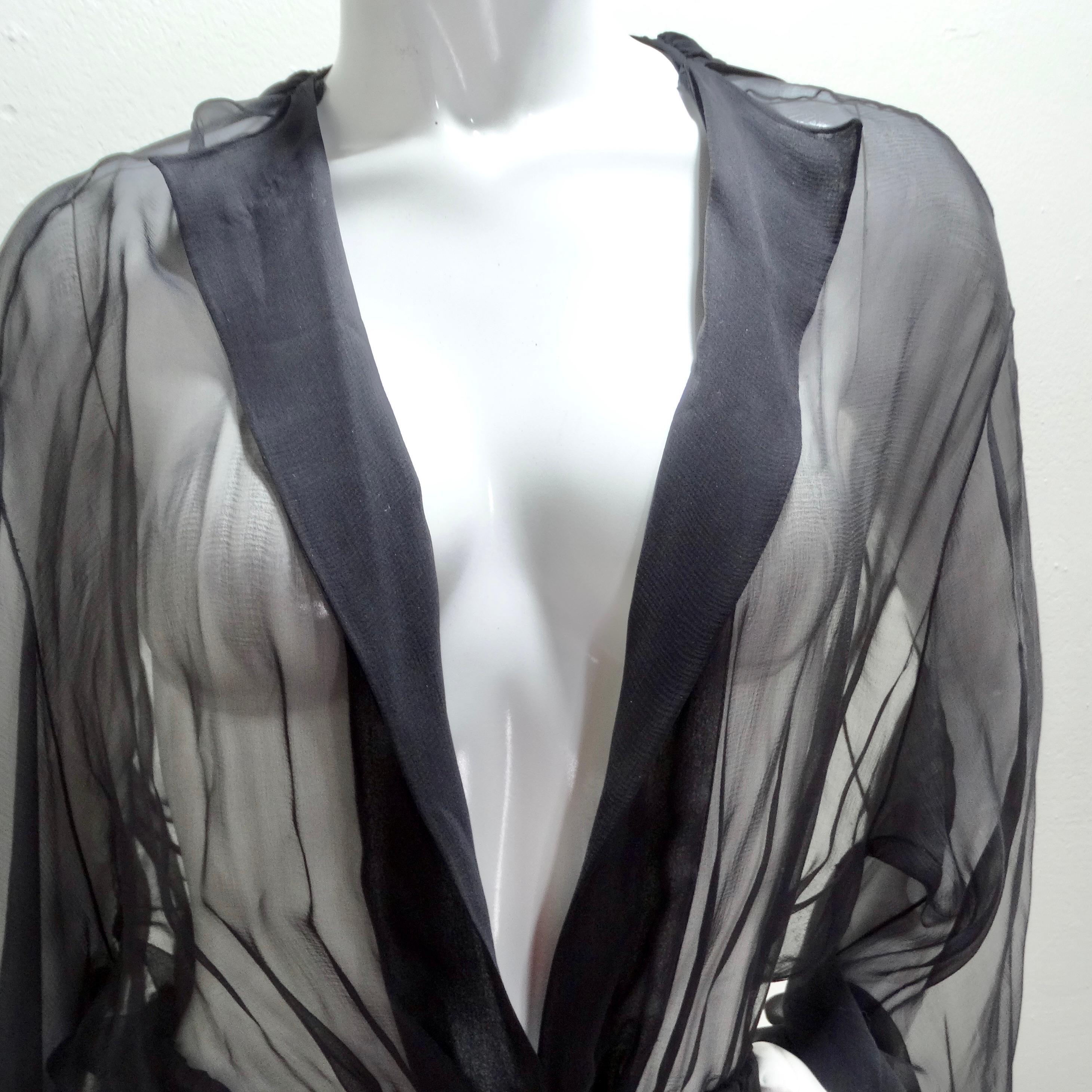 Introducing the 1980s Sheer Silk Hooded Robe – a mesmerizing and versatile wardrobe essential that effortlessly blends luxury with a touch of bohemian flair. This floor-length sheer black silk robe is not just a garment; it's a unique styling piece