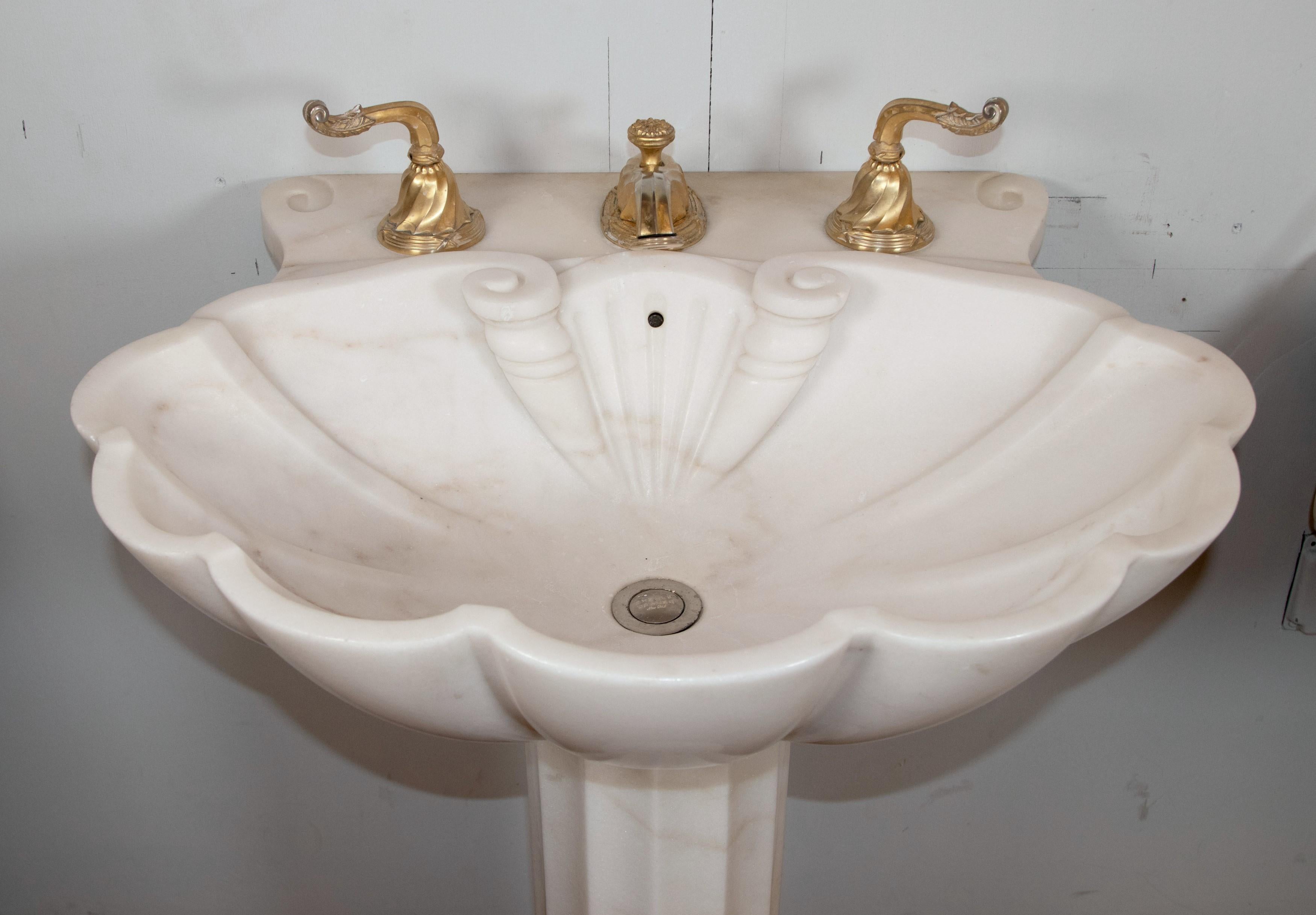 Sheryl Wagner pedestal sink with gilt hardware in a white and gray veined marble construction. Good condition with appropriate wear from age. One available. Please note, this item is located in one of our NYC locations.