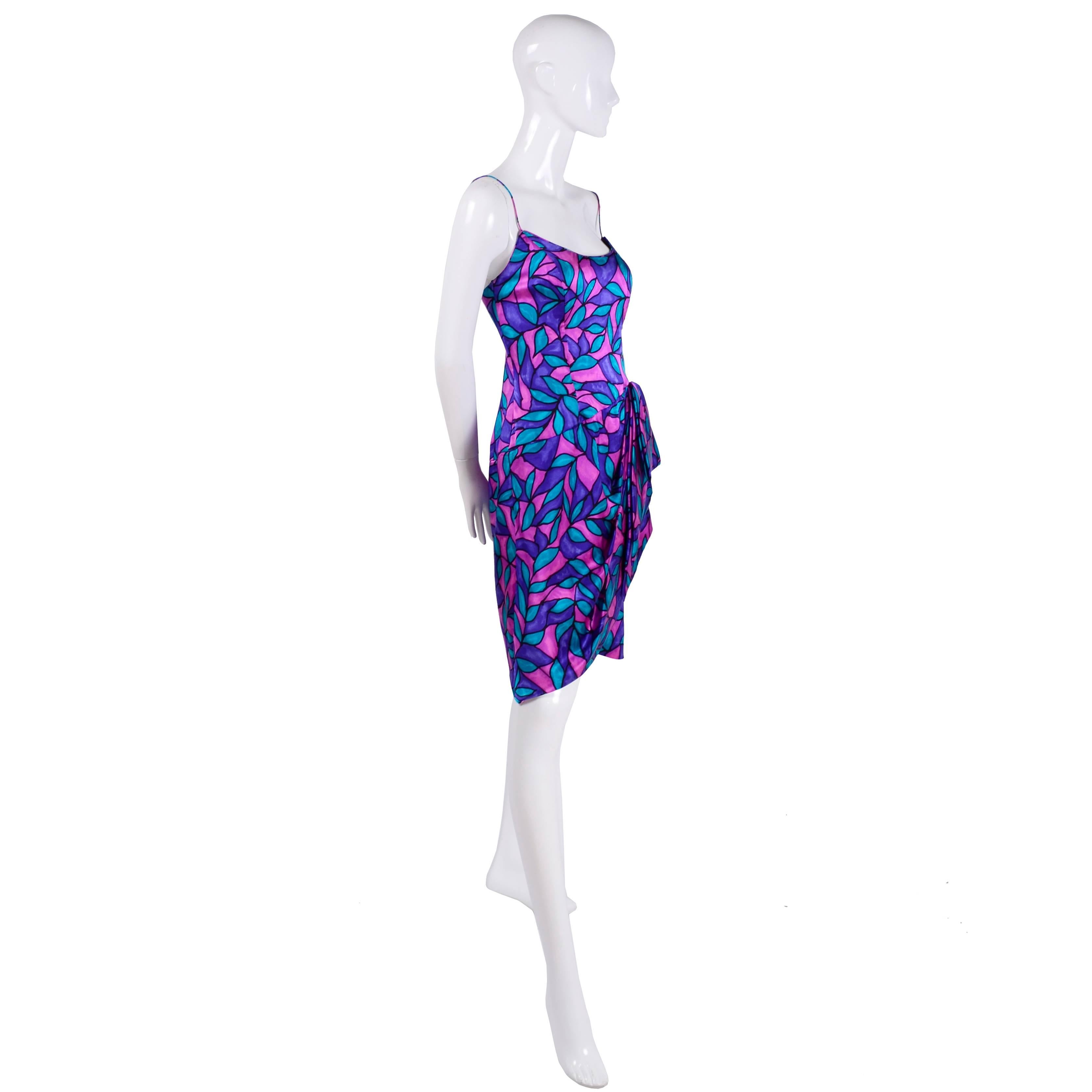 This colorful vintage silk dress was made by AJ Bari in the 1980’s. The 80's were definitely back on the runways in designer collections for 2018/19 and we think this dress fits perfectly into that trend with its hemline and side drape. The purple,