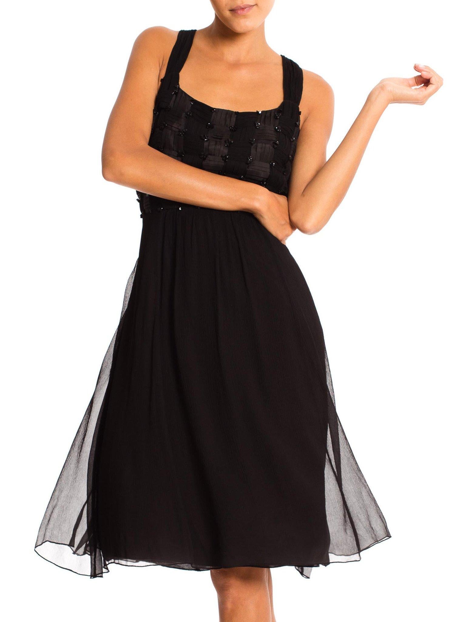 No label in this very high quality dress. The bodice is a work of art with the intricately pleated and woven textile. Lined in rayon with an attached silk sash to adjust the waist.  1980'S Black Silk Mousseline & Satin Basket-Weave Bodice Cocktail