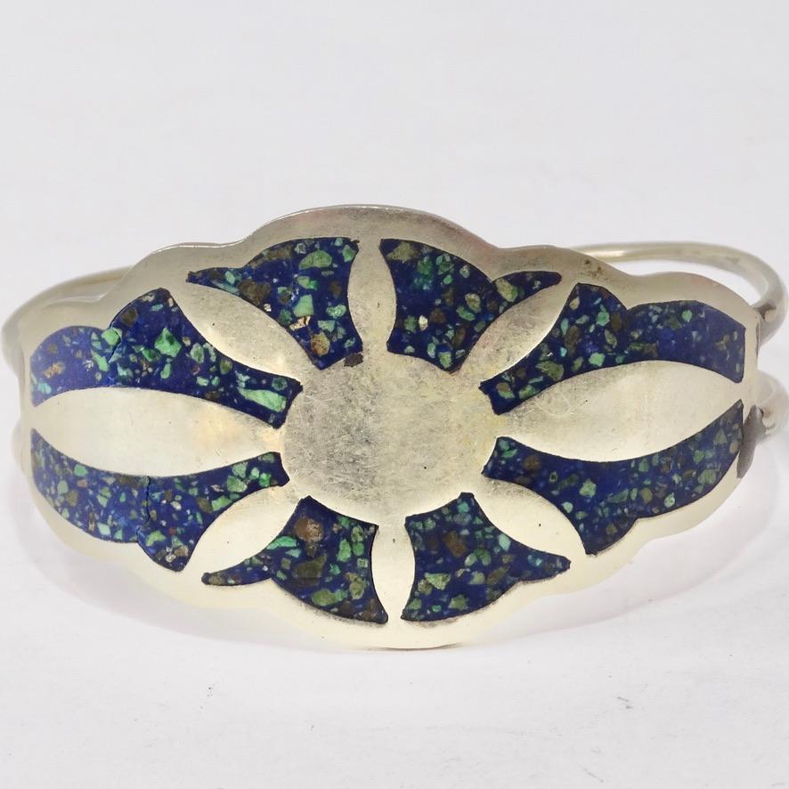 This 1970 silver cuff bracelet is begging to be added to your collection! Beautiful silver cuff style bracelet features an eye catching silver sun motif alongside a turquoise inlay. The turquoise adds the perfect pop of color and a vintage feel to