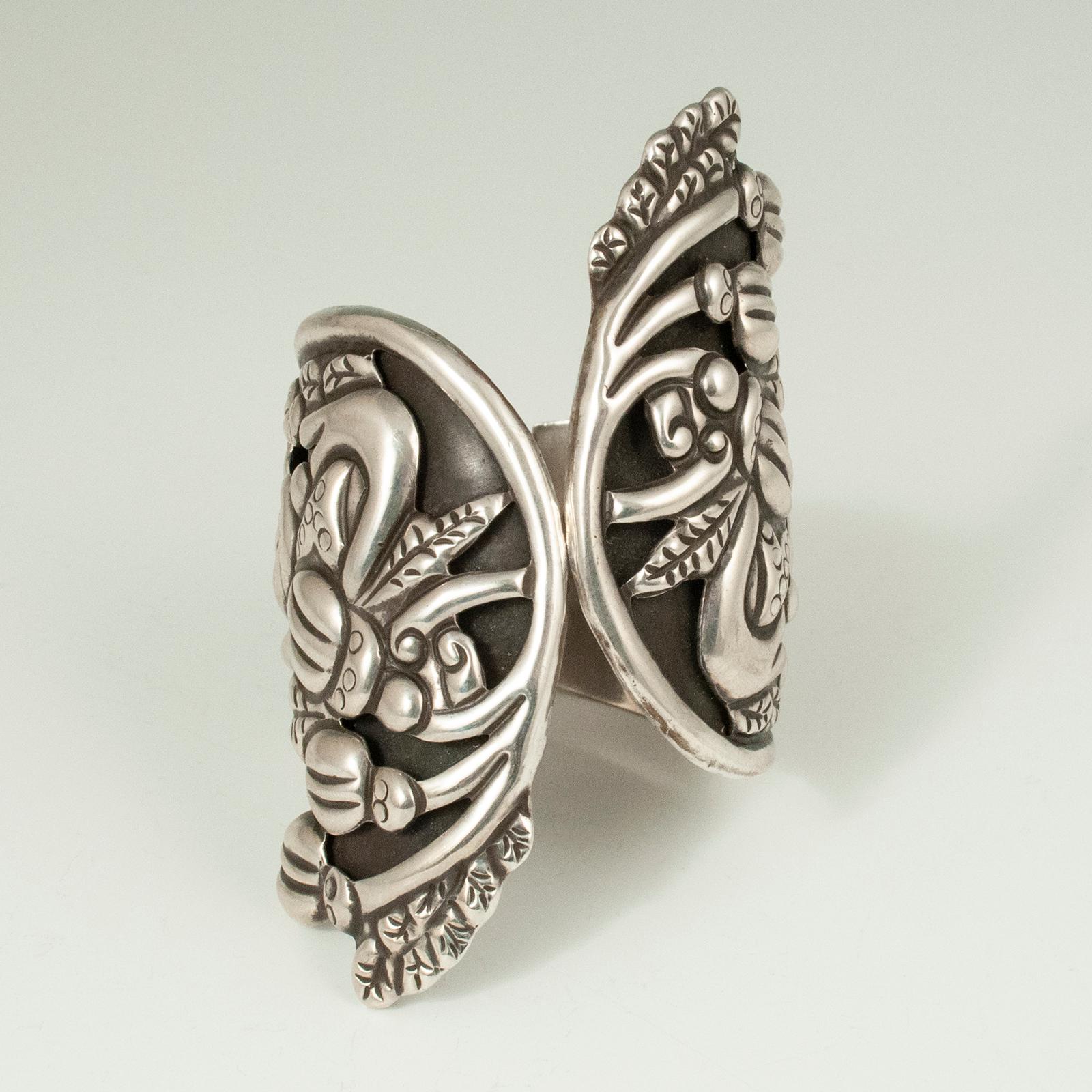 1980s silver clamper bracelet, Taxco, Mexico

This beautiful repoussé silver floral clamper bracelet is adorned with leaves and acorns or buds. The marks inside are: a double-stamped CP inside an illegible circle that includes 925 and possibly