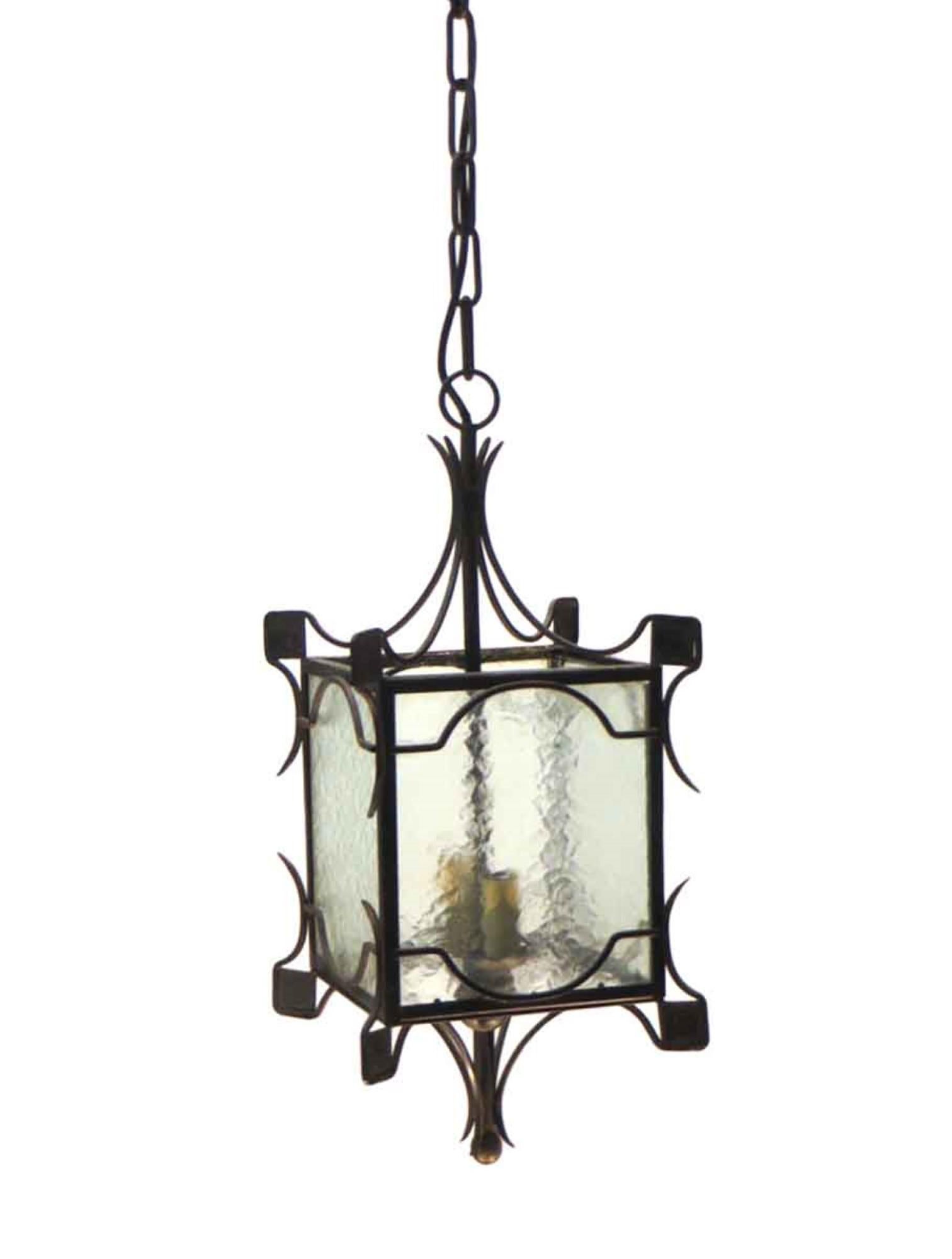 1980s pendant lantern made of wrought iron with a black finish with clear hammered glass. Takes two bulbs. New wiring. This can be seen at our 400 Gilligan St location in Scranton, PA