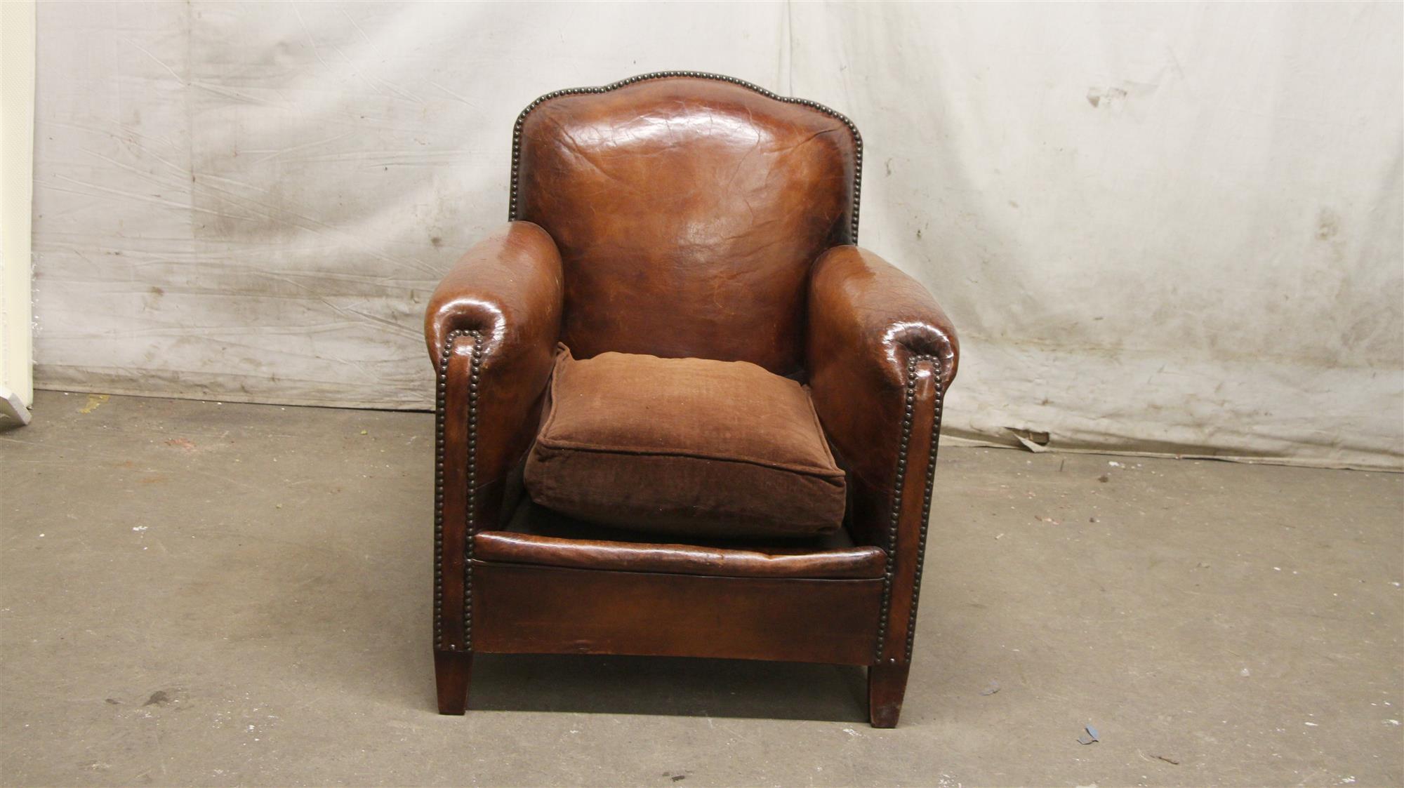 1980s brown leather vintage club chair with wooden feet from France. This can be seen at our 5 East 16th St location on Union Square in Manhattan.