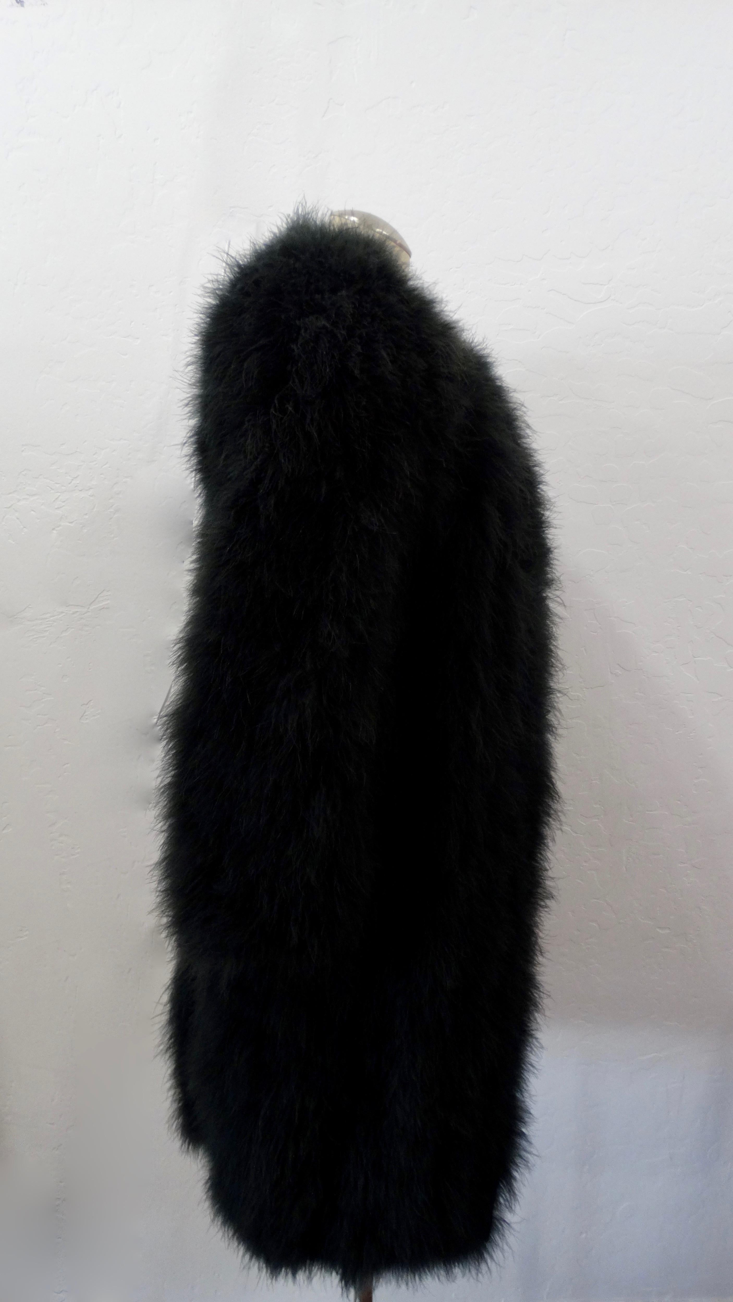 Elevate all of your winter looks with this amazing coat! Circa 1980s, this Sonia Rykiel coat is made of soft black Marabou feathers. Features long sleeves, a single hook and eye closure at the neckline and a fully lined interior (100% Acetate).